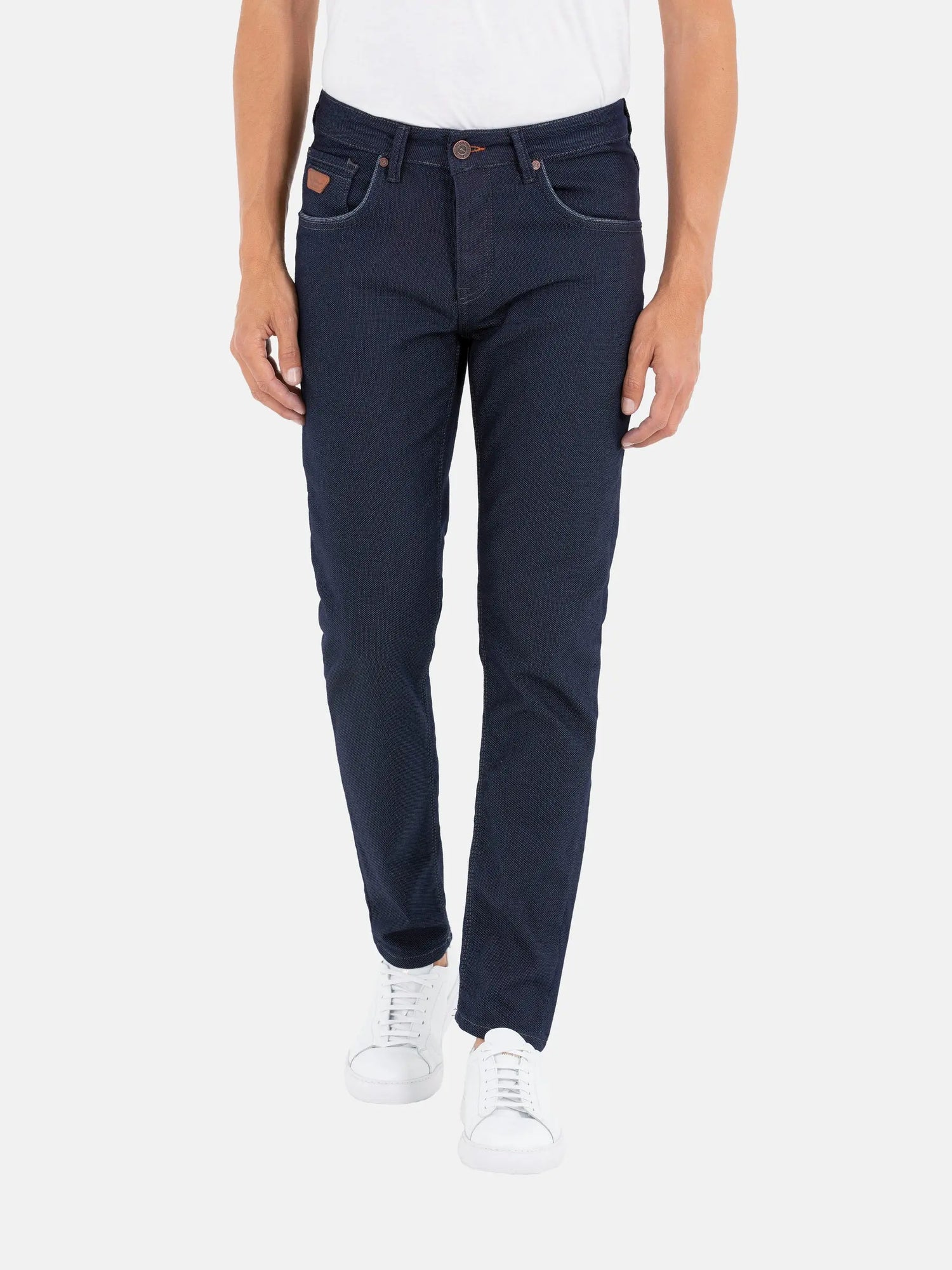 Men’s slim-fit dark blue jeans paired with white sneakers – Wam Denim.