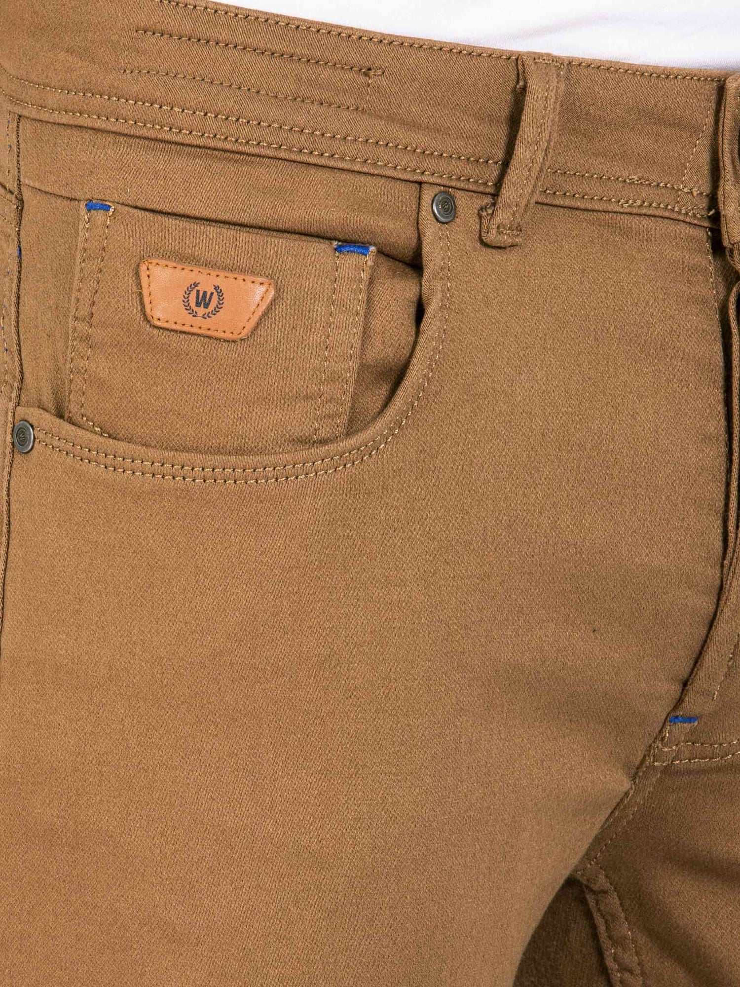 Close-up of camel brown jeans front pocket with stitching and leather Wam Denim logo patch – Wam Denim.