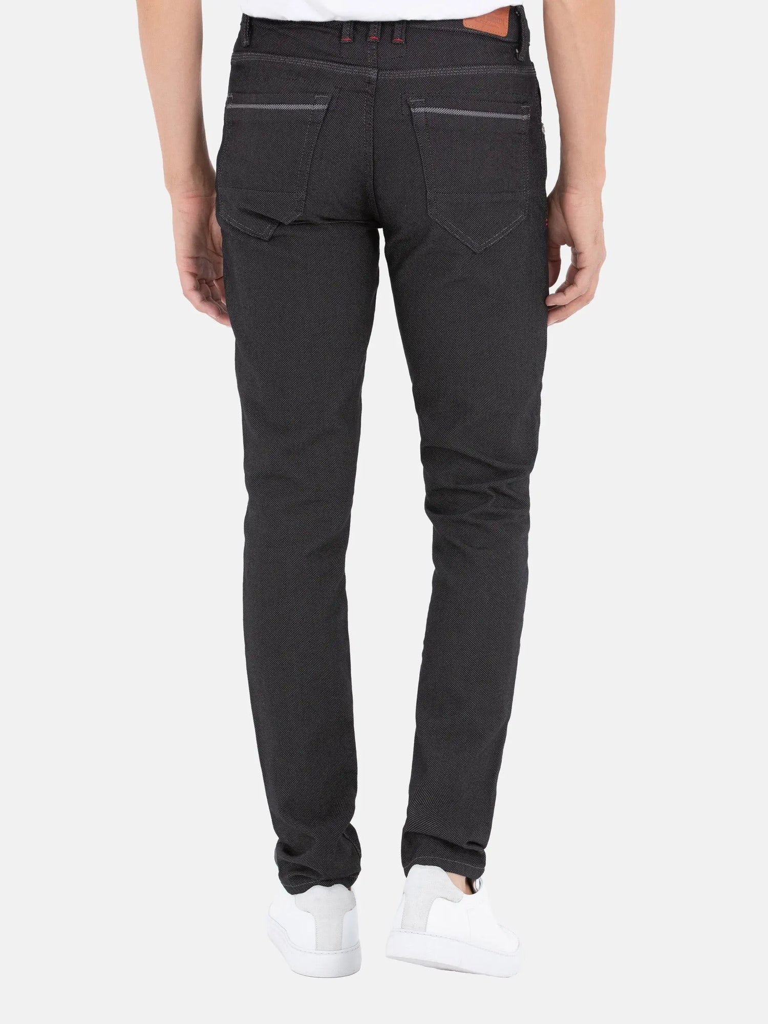 Back view of slim-fit black patterned jeans with detailed stitching and pockets – Wam Denim.