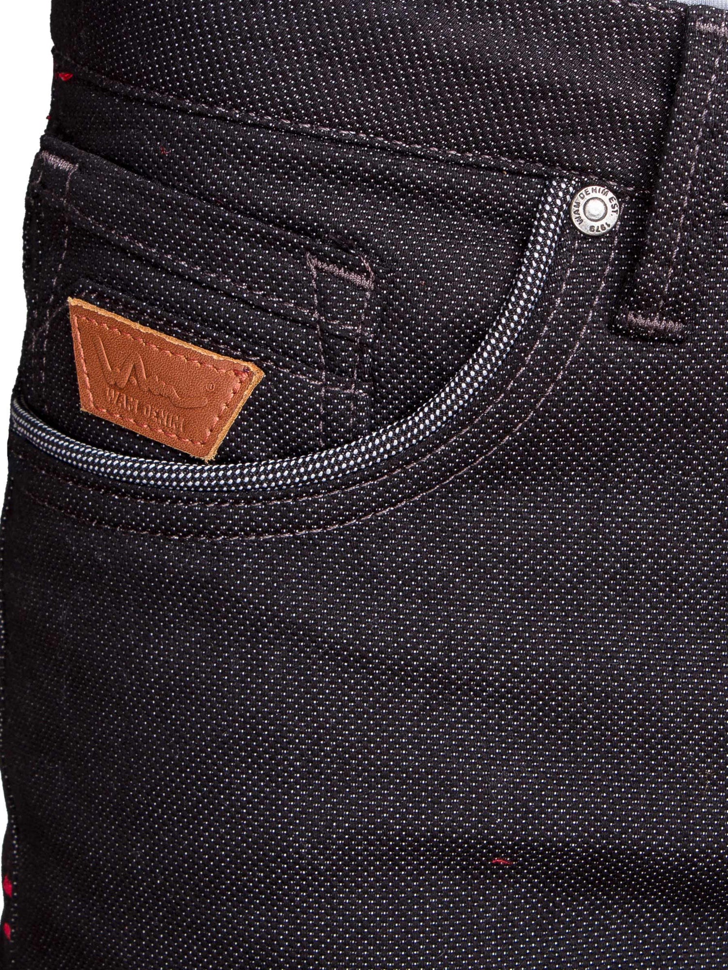 Close-up of black denim jeans front pocket with contrast stitching and leather Wam Denim tag – Wam Denim.