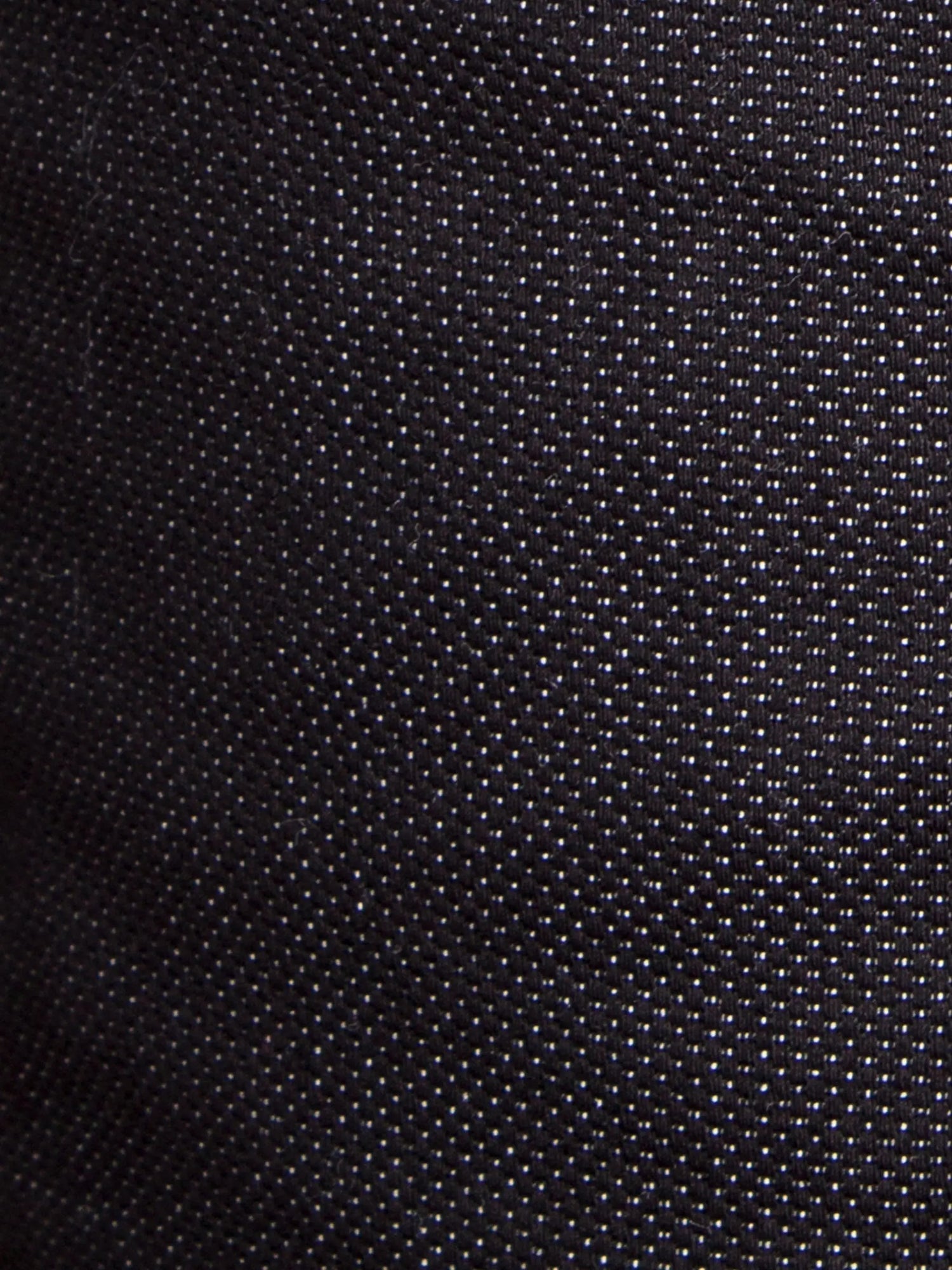 Close-up of black textured denim fabric with fine dotted weave pattern – Wam Denim.