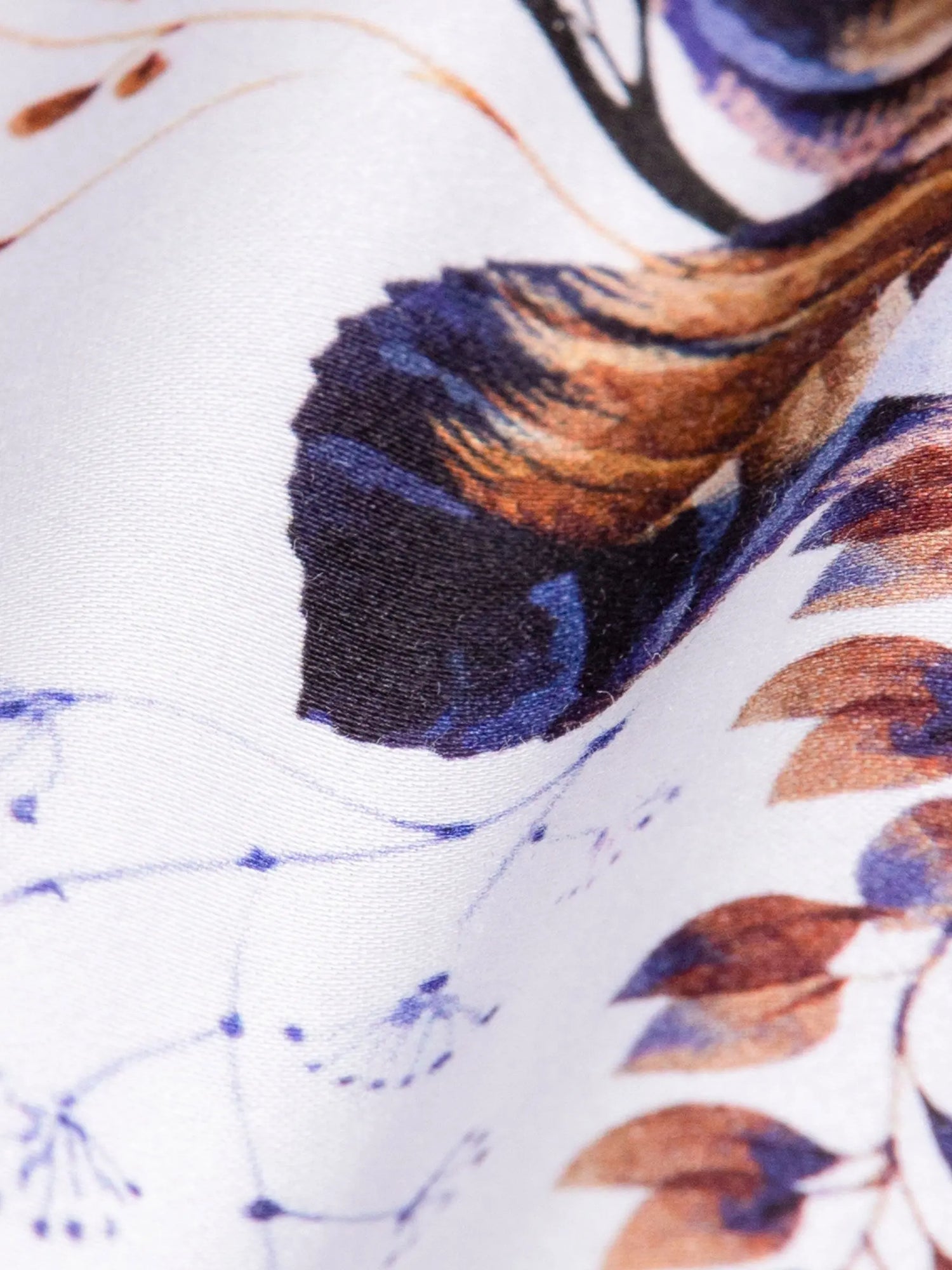 Close-up of a fabric with abstract pattern featuring blue, brown, and black colors.