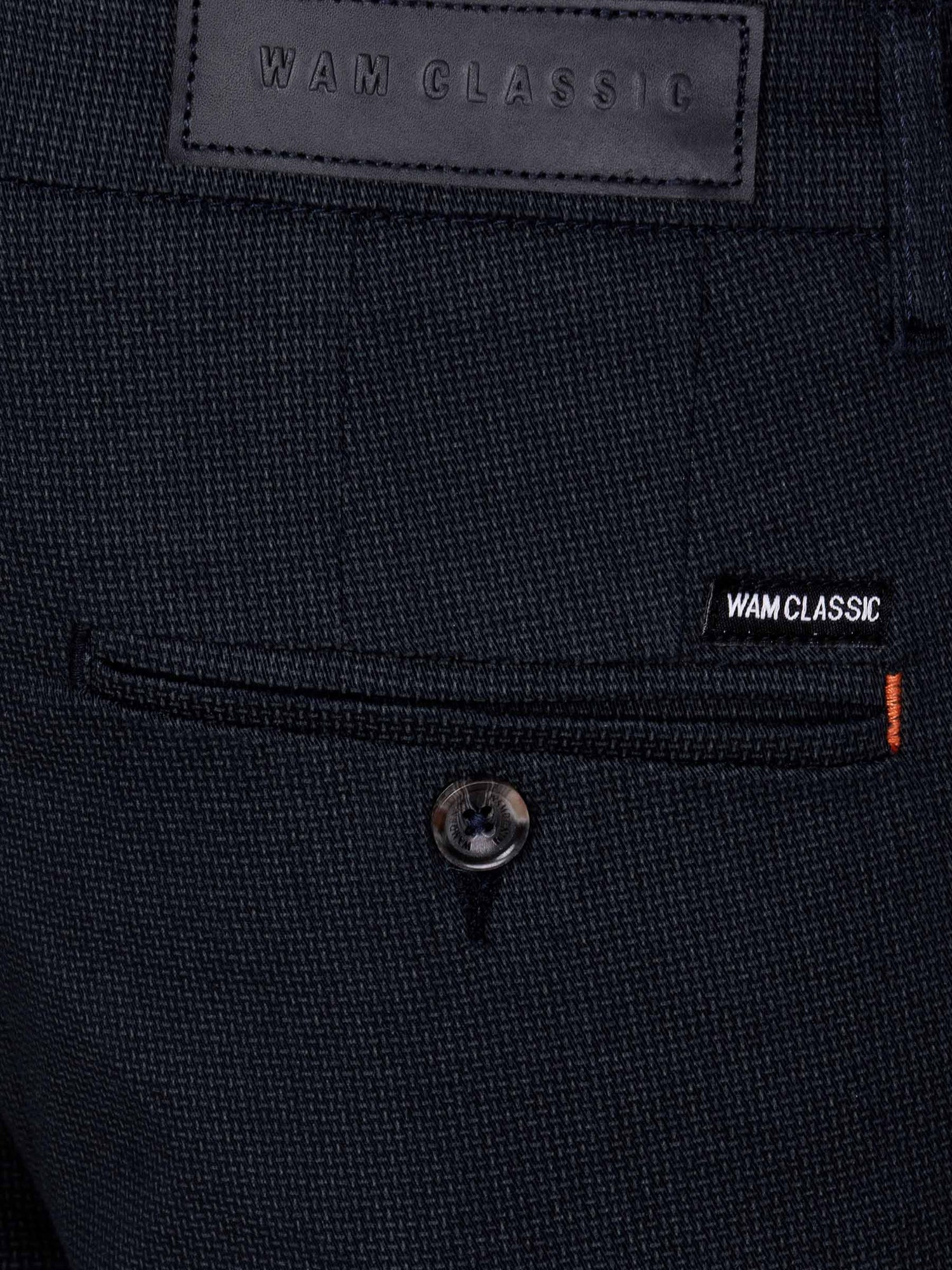 Close-up of navy textured chinos with Wam Classic label and buttoned back pocket – Wam Denim.