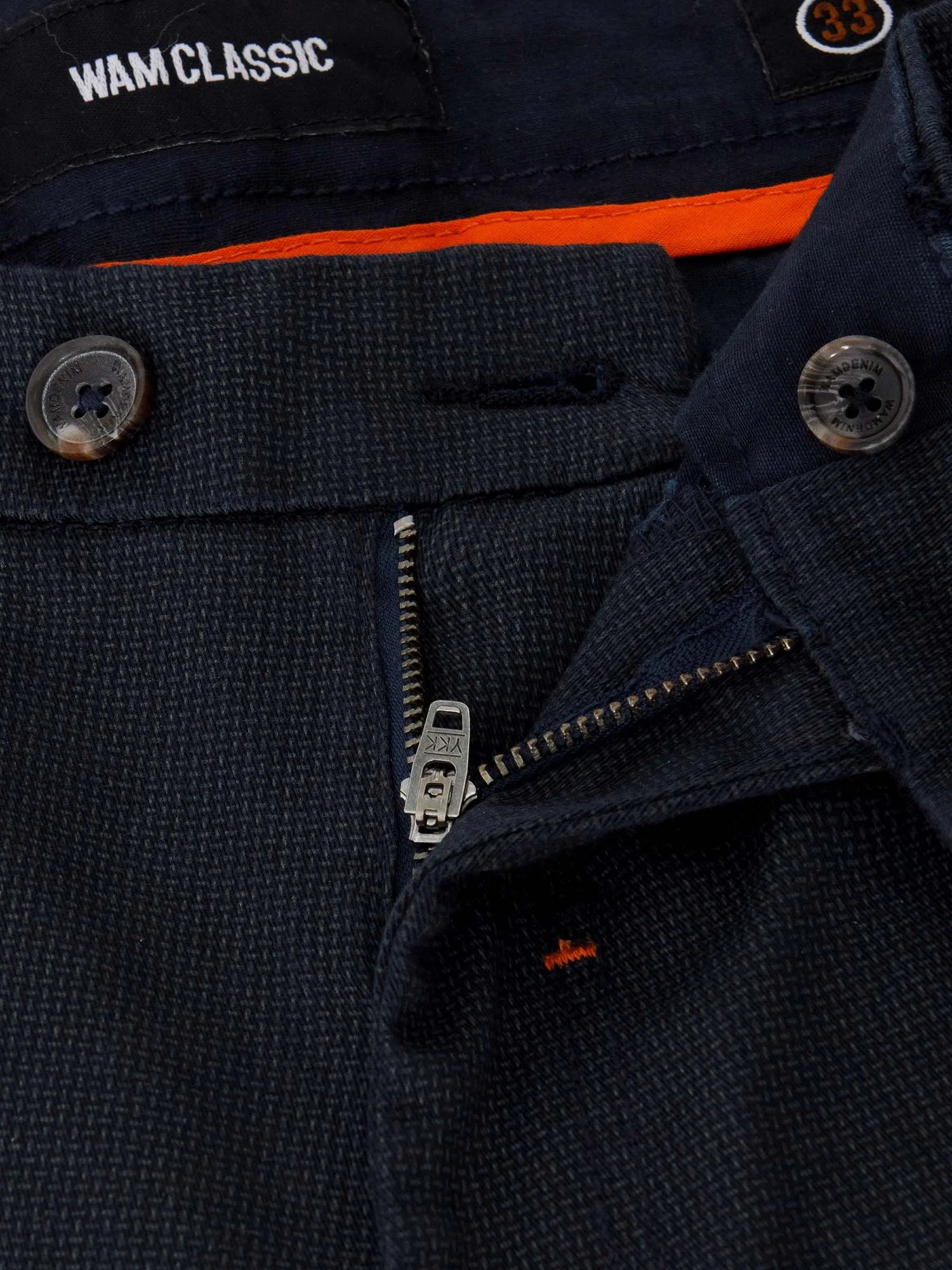 Close-up of navy textured chinos showing zipper, button, and Wam Classic label – Wam Denim.