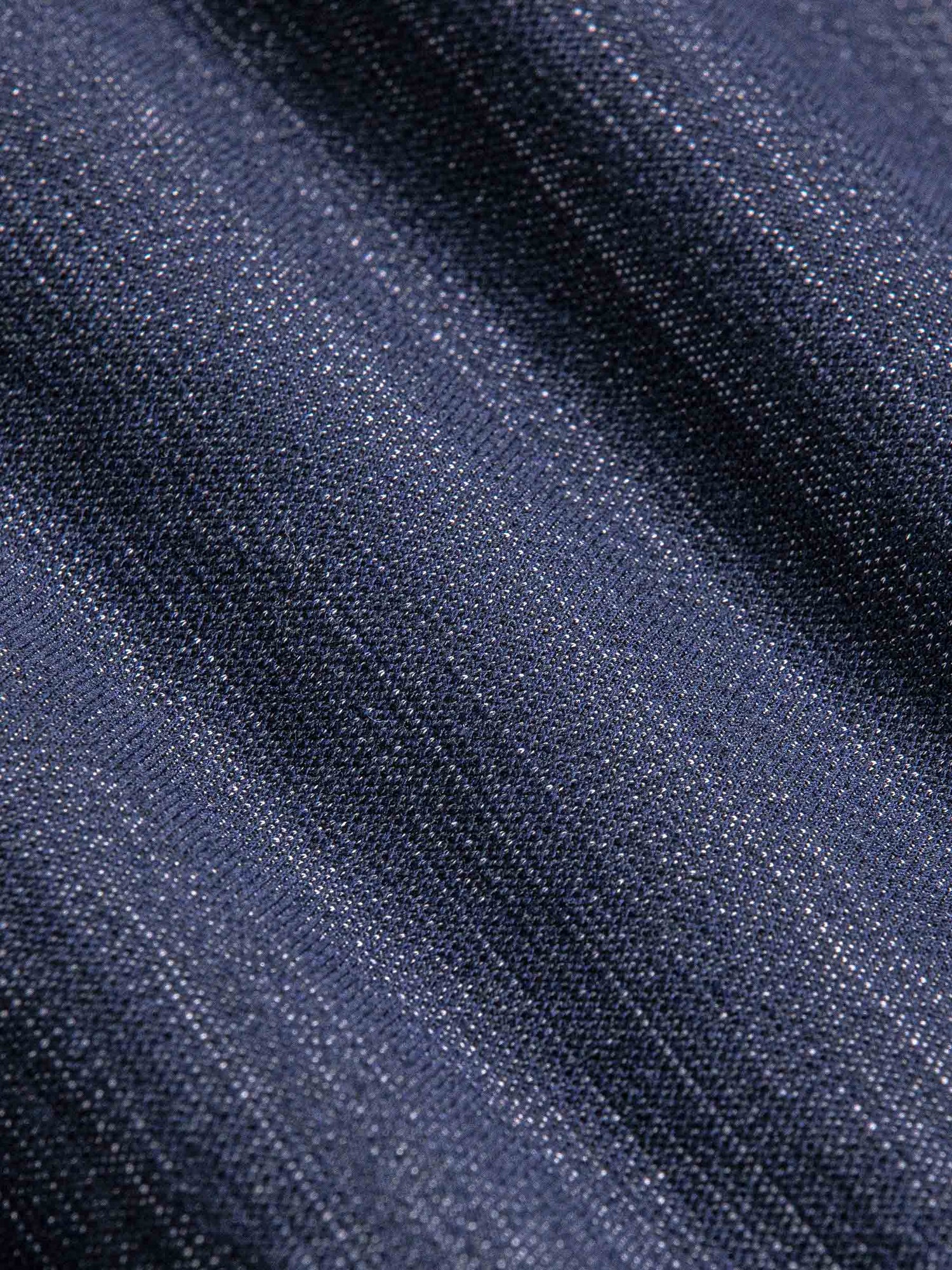 Close-up of sweater fabric with a subtle pattern