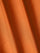 Close-up of smooth orange fabric highlighting soft texture and premium quality – Wam Denim.