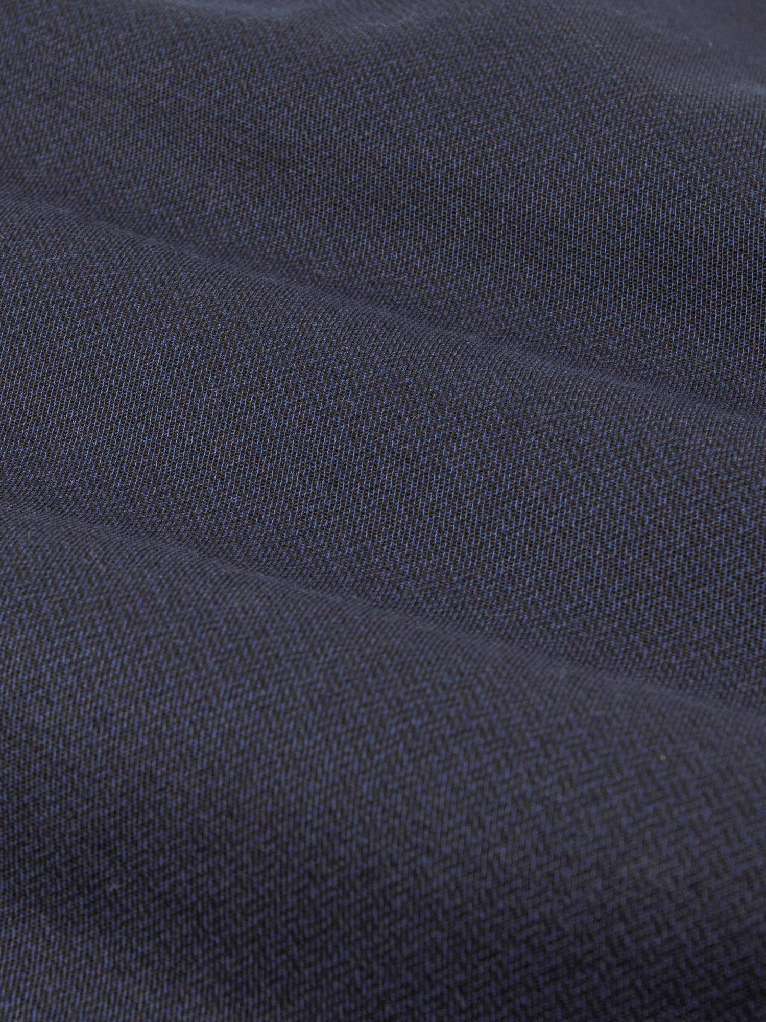 Close-up of dark blue denim fabric with textured weave. – Wam Denim.