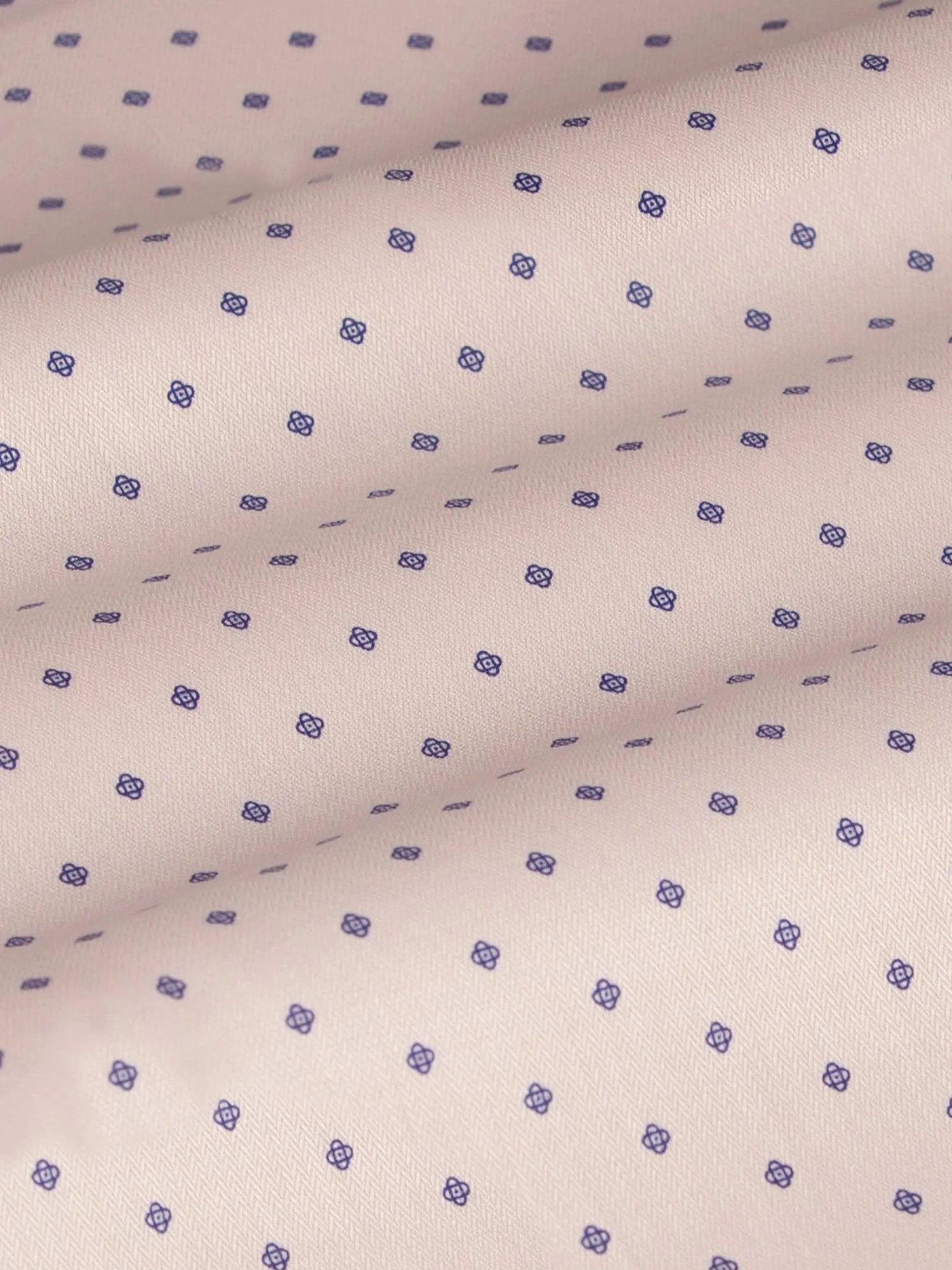Close-up of beige fabric with purple dot pattern, textured. – Wam Denim.
