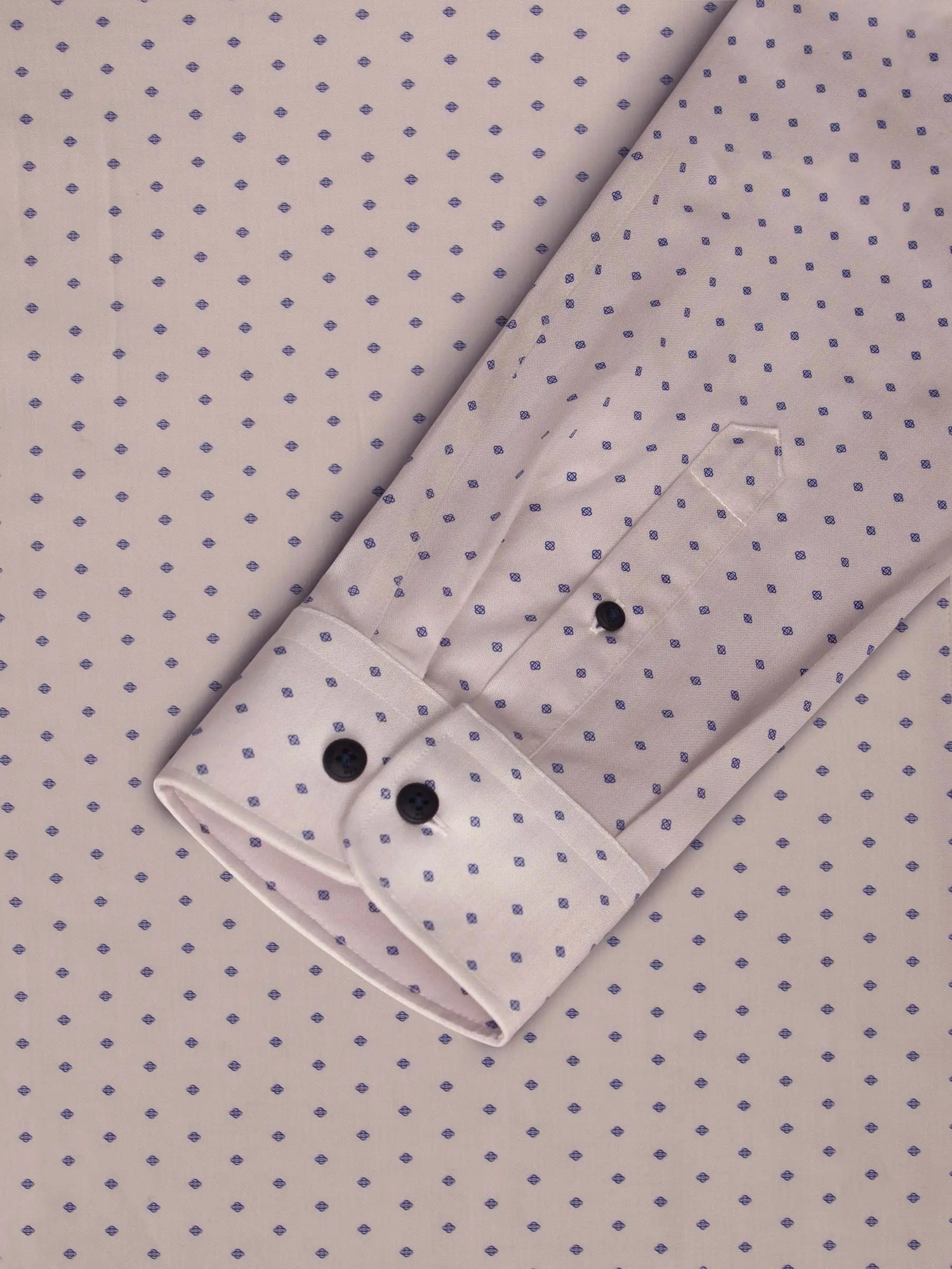 Close-up of beige shirt cuff with purple dot pattern. – Wam Denim.