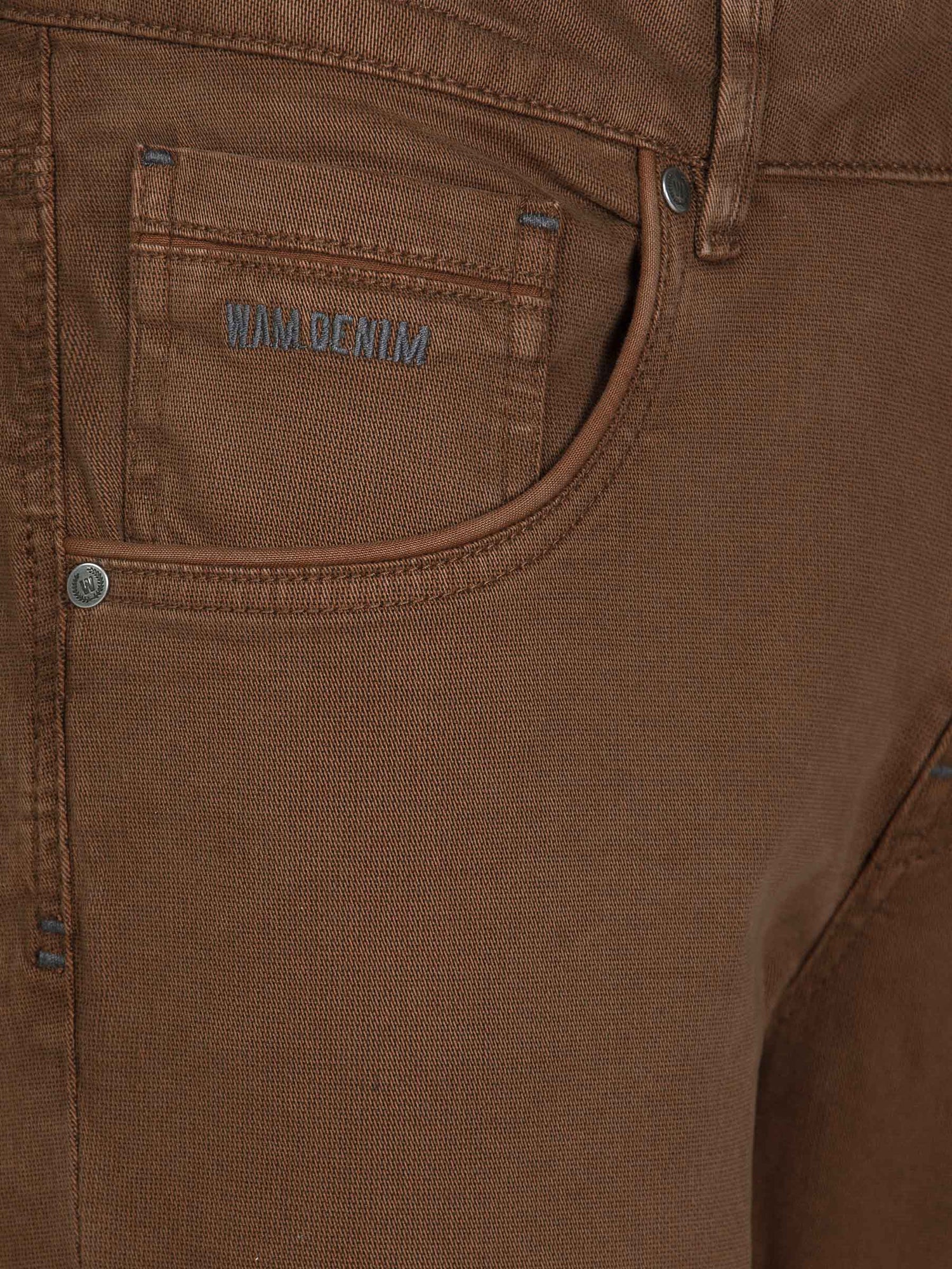 Close-up of brown jeans hem with rugged denim texture. – Wam Denim.