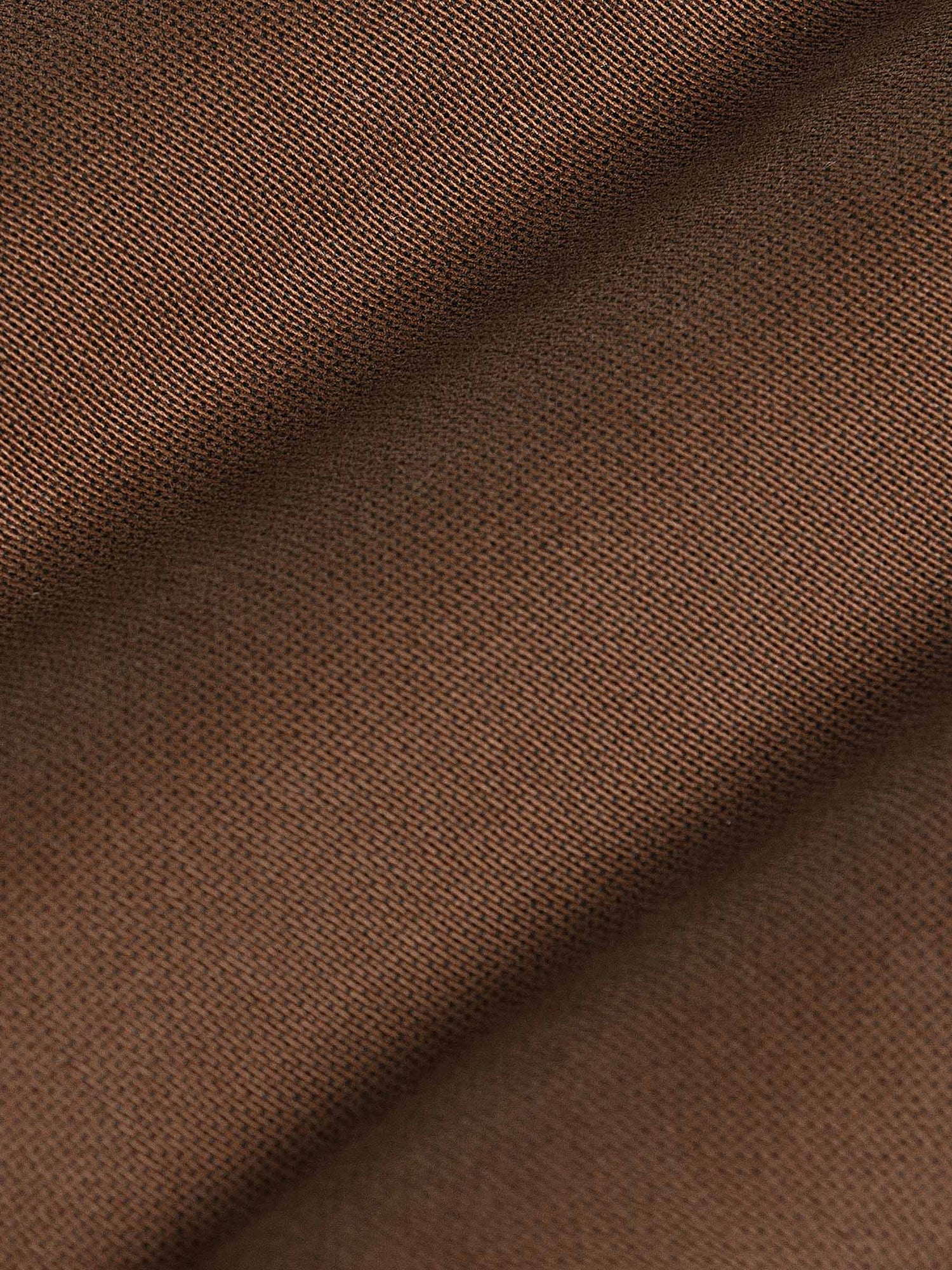 Close-up of brown jeans zipper with durable denim finish. – Wam Denim.