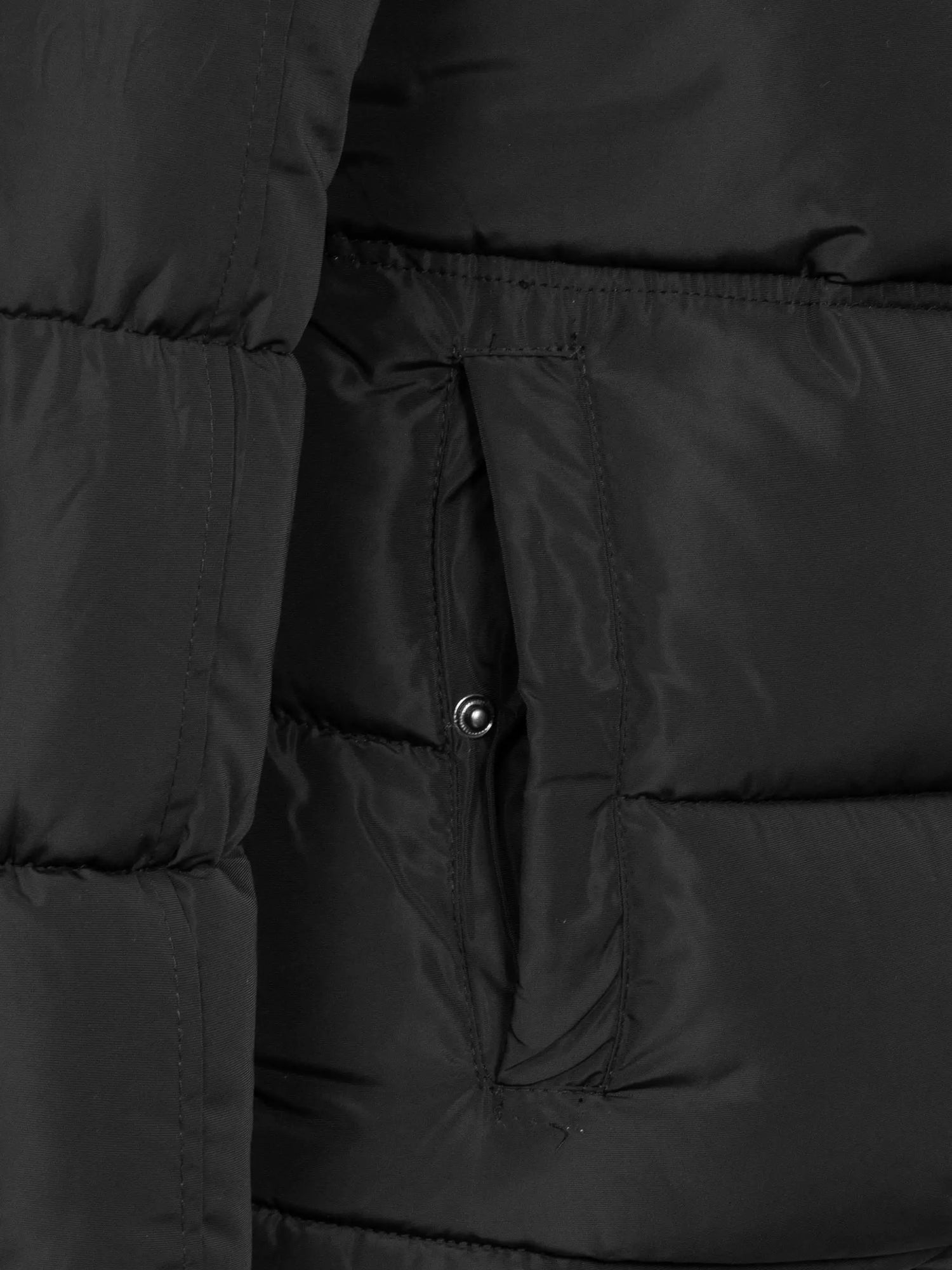 Close-up of the snap-button side pocket on the black puffer – Wam Denim.
