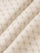 Close-up of beige fabric with geometric stitched pattern for hoodie texture – Wam Denim.