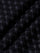 Close-up of black fabric with stitched geometric logo pattern and soft texture – Wam Denim.