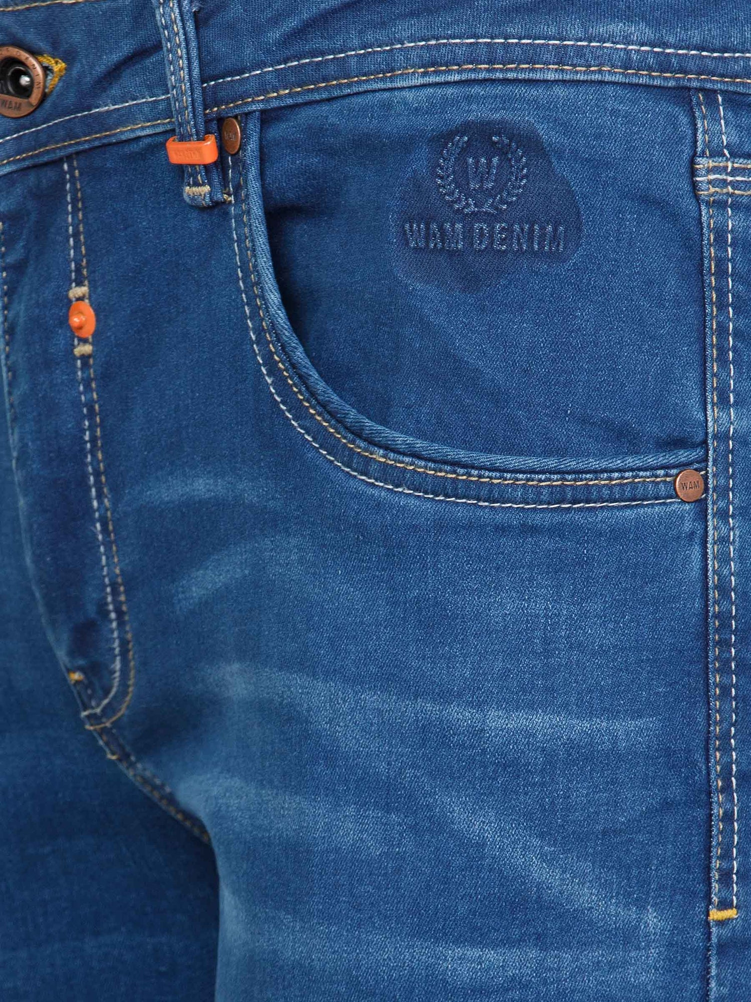Close-up of light blue jeans pocket with embossed Wam Denim logo and orange accents – Wam Denim.