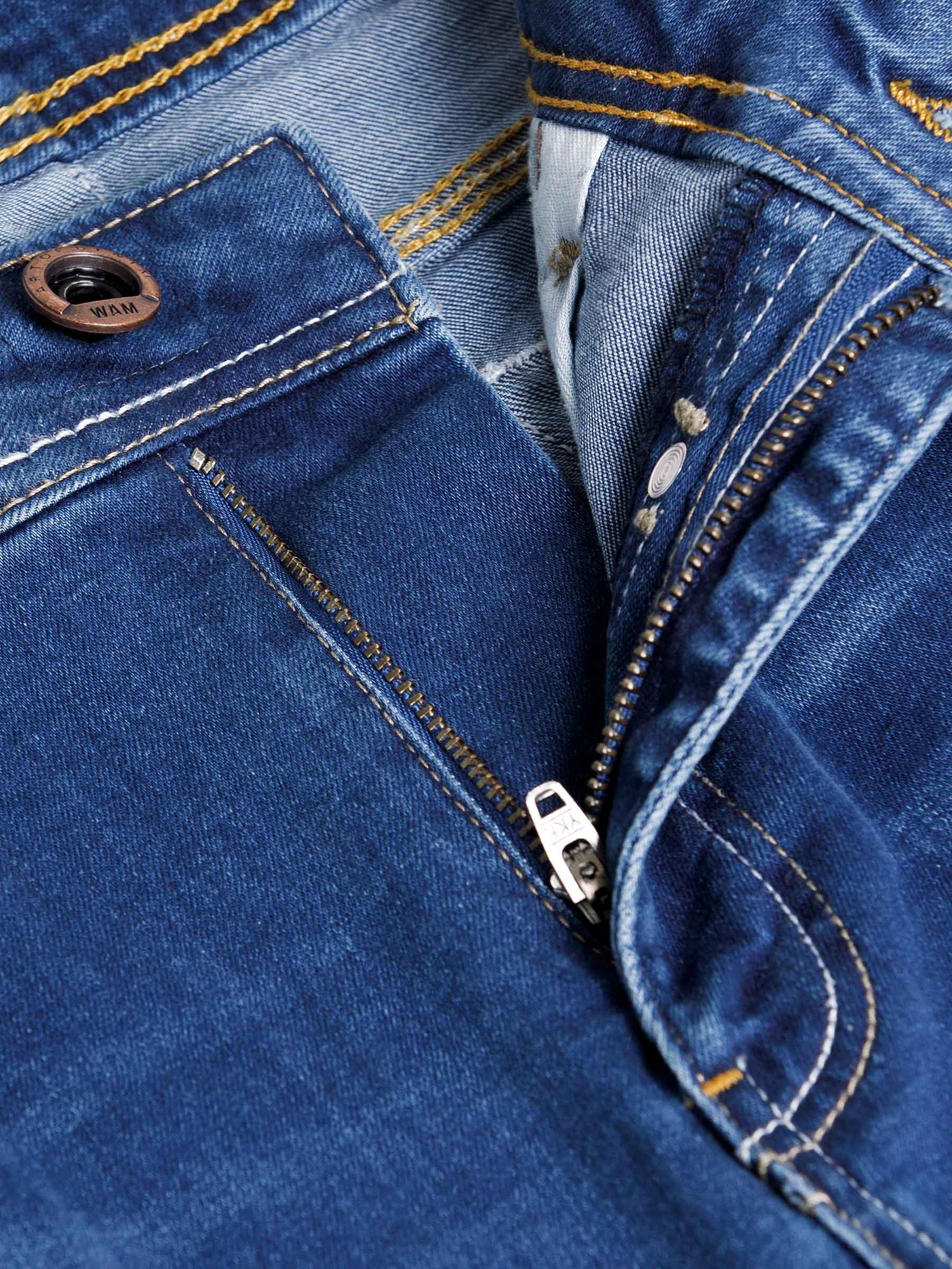 Close-up of light blue jeans zipper and button with contrast stitching detail – Wam Denim.