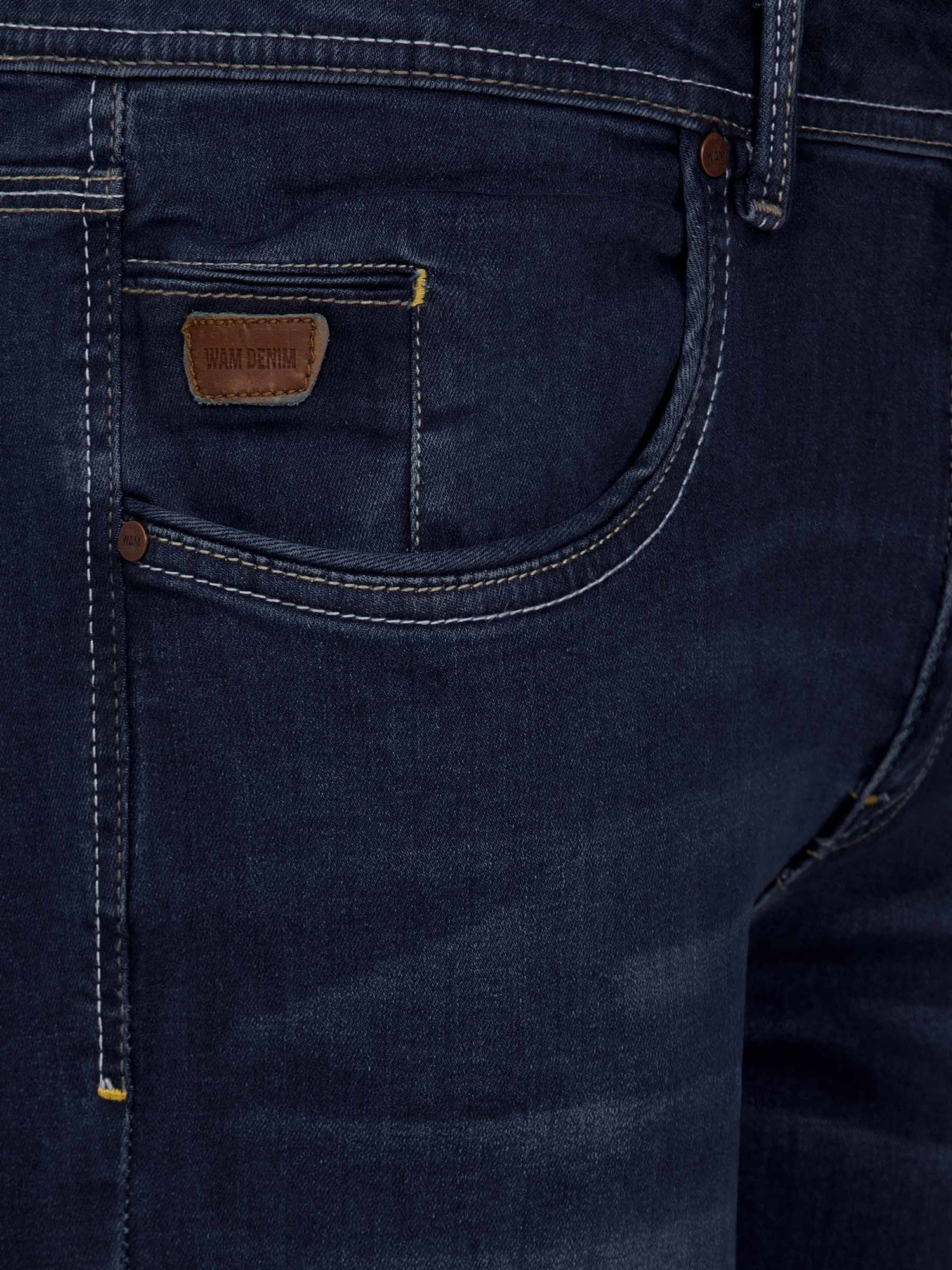 Front pocket close-up of dark navy jeans with leather Wam Denim label and contrast stitching – Wam Denim.
