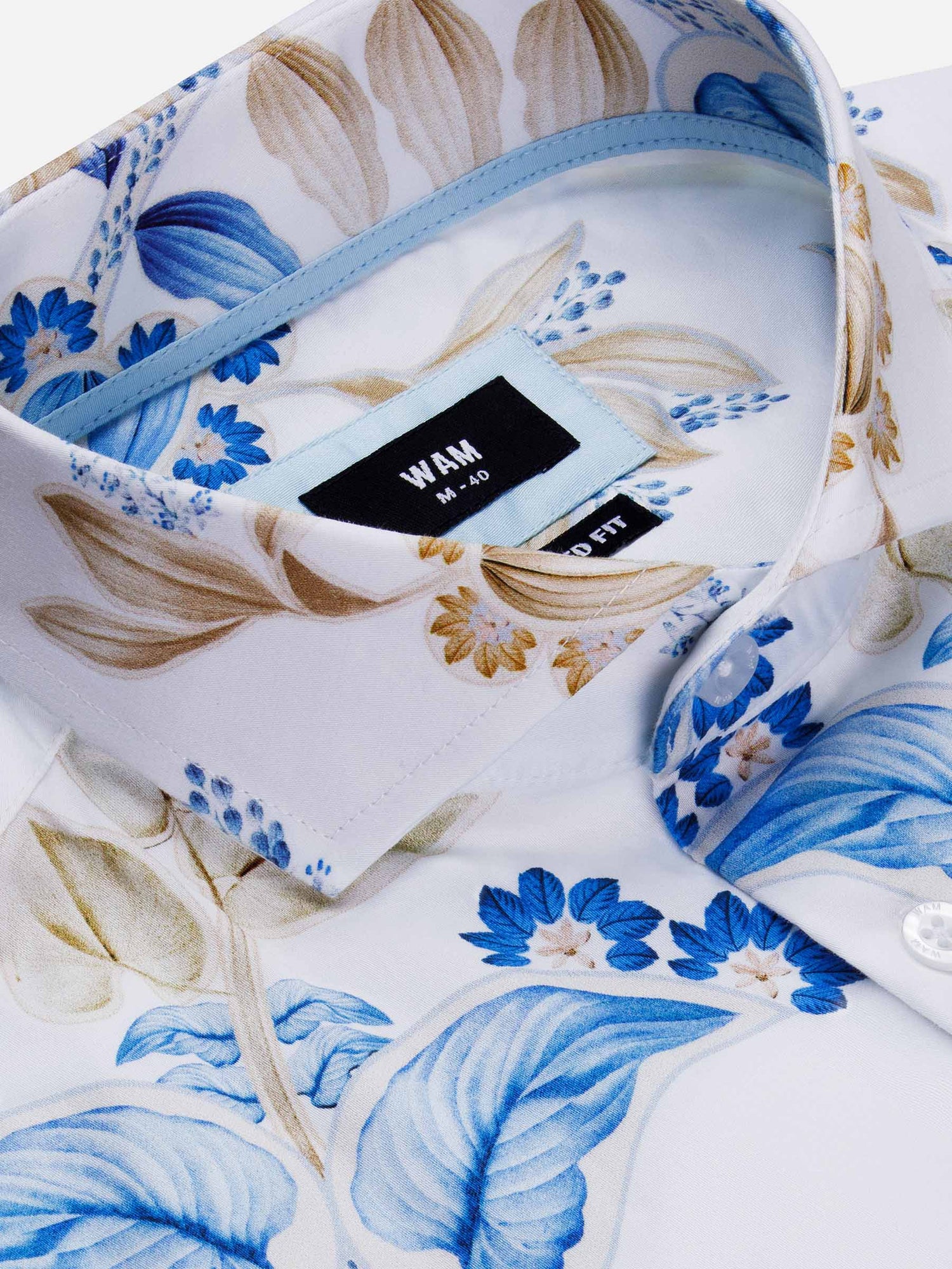 Close-up of blue and beige floral shirt collar with WAM tailored fit label – Wam Denim.