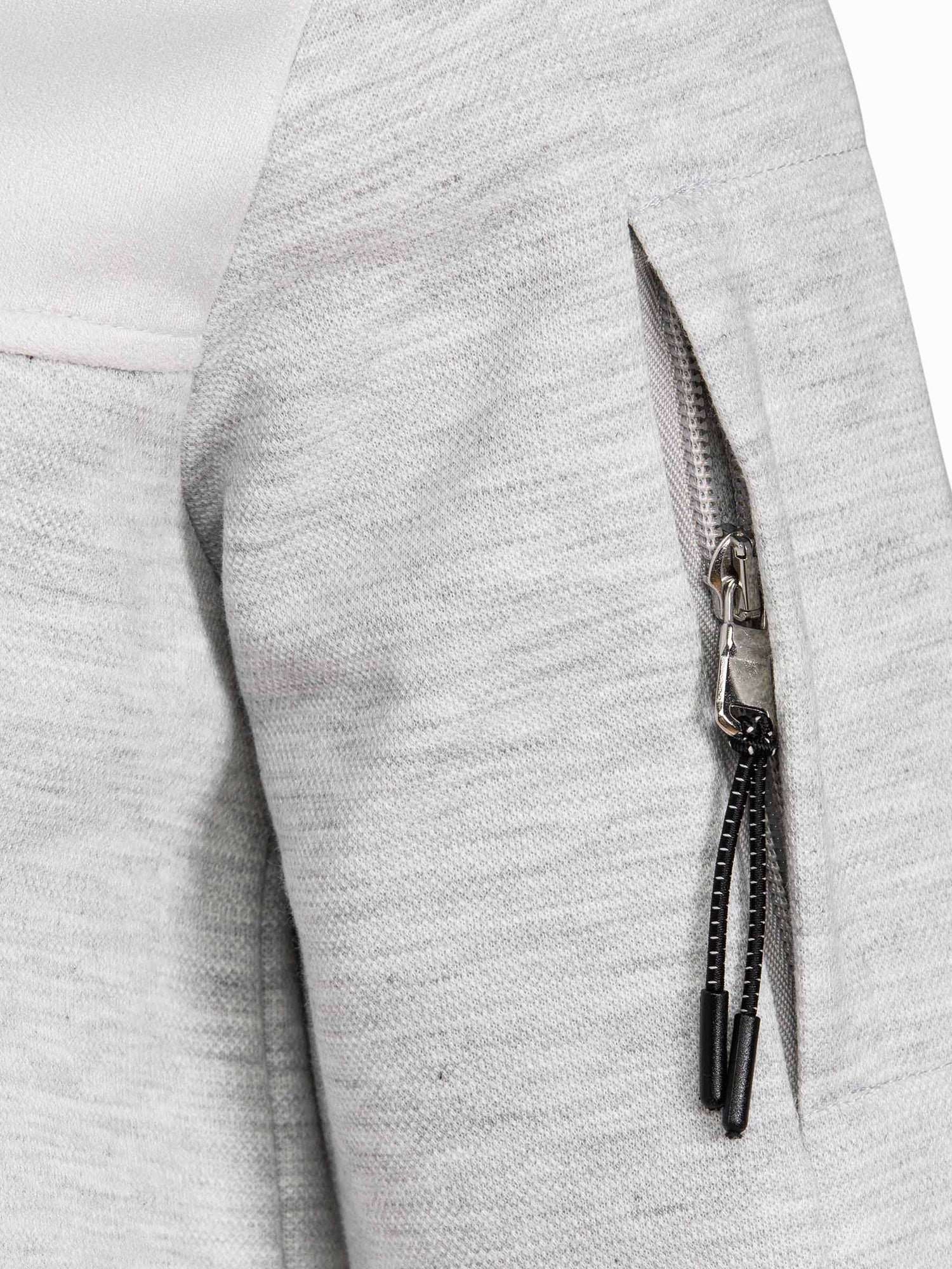 Close-up of sleeve zipper pocket detail on light grey sweatshirt fabric – Wam Denim.