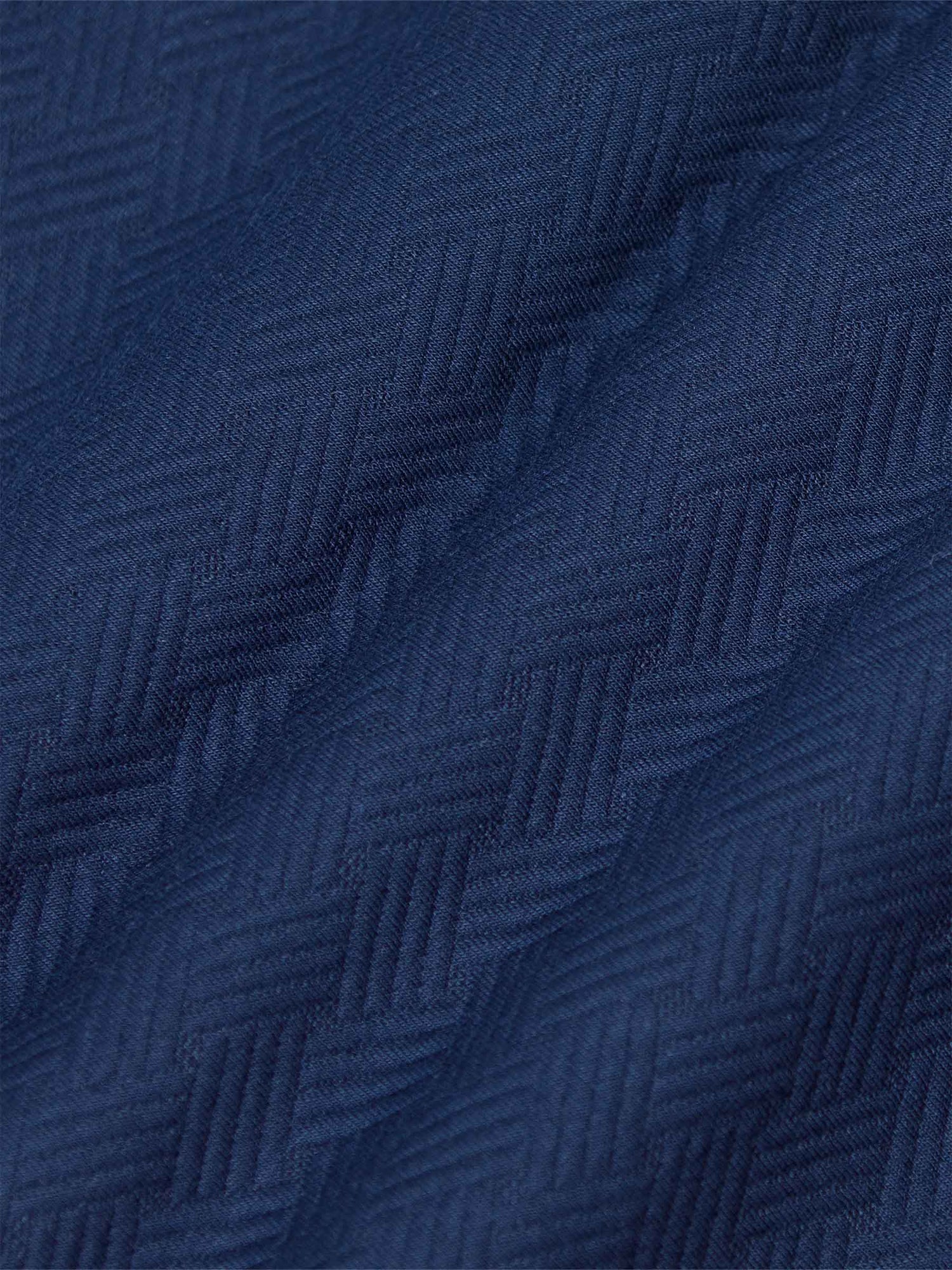 Close-up of textured navy Moorland Sweater fabric. – Wam Denim.