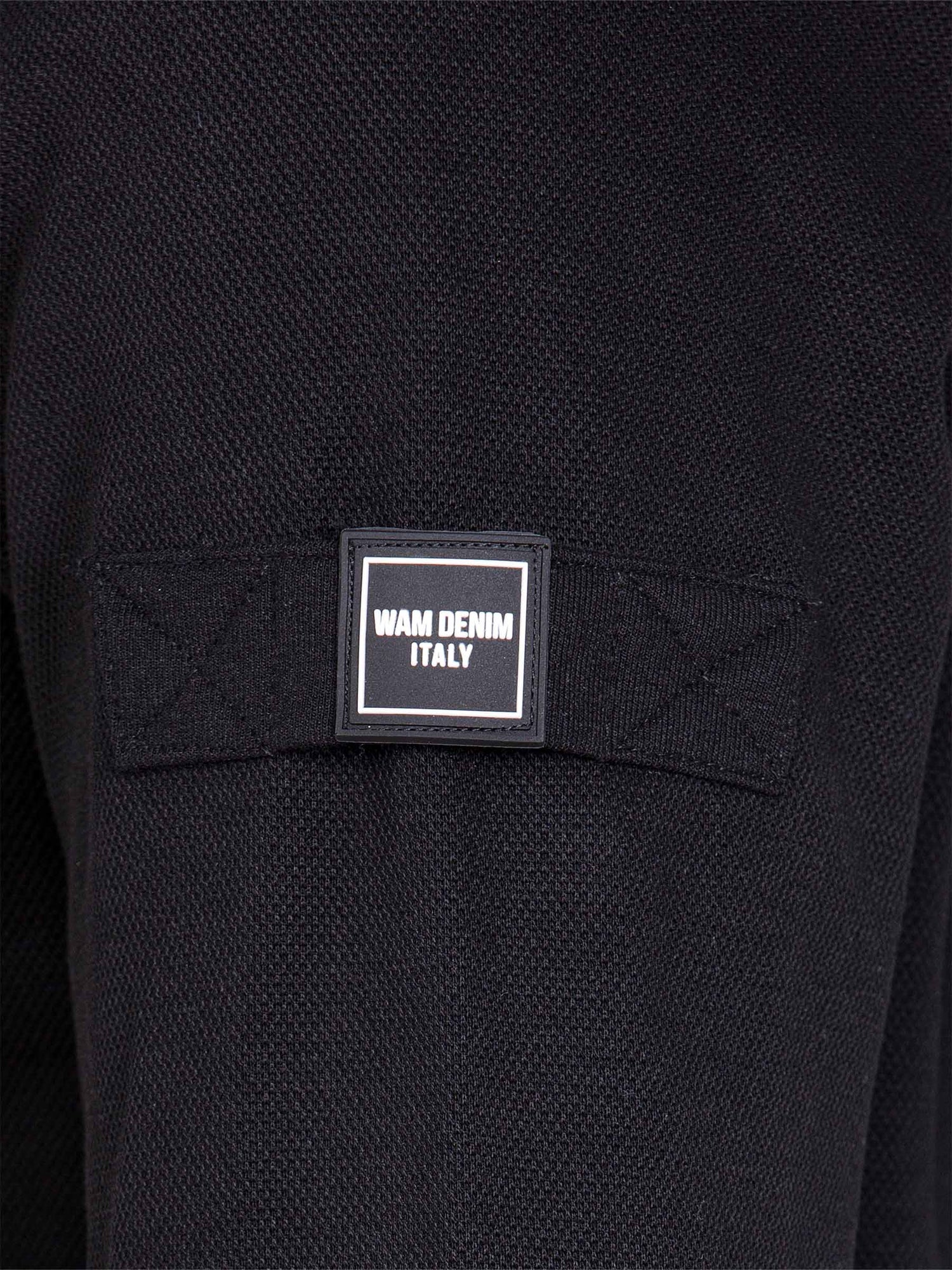 Close-up of sleeve patch with Wam Denim Italy logo on black textured sweater – Wam Denim.