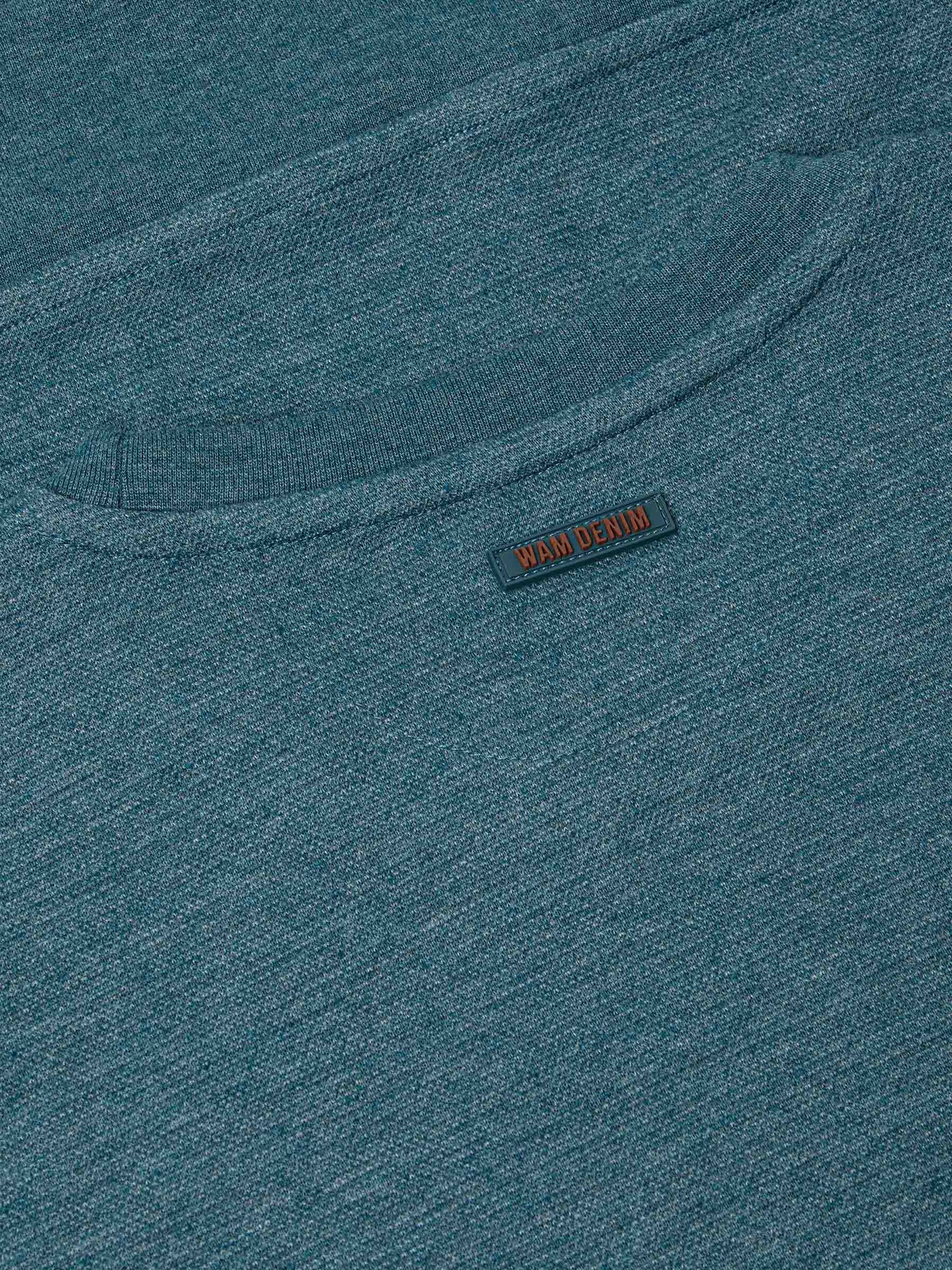 Close-up of back neck area with subtle Wam Denim logo tag on petrol fabric – Wam Denim.