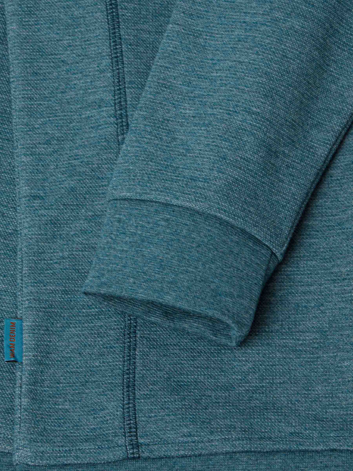 Cozy teal Rustic Petrol Sweater with textured knit and orange logo. – Wam Denim.