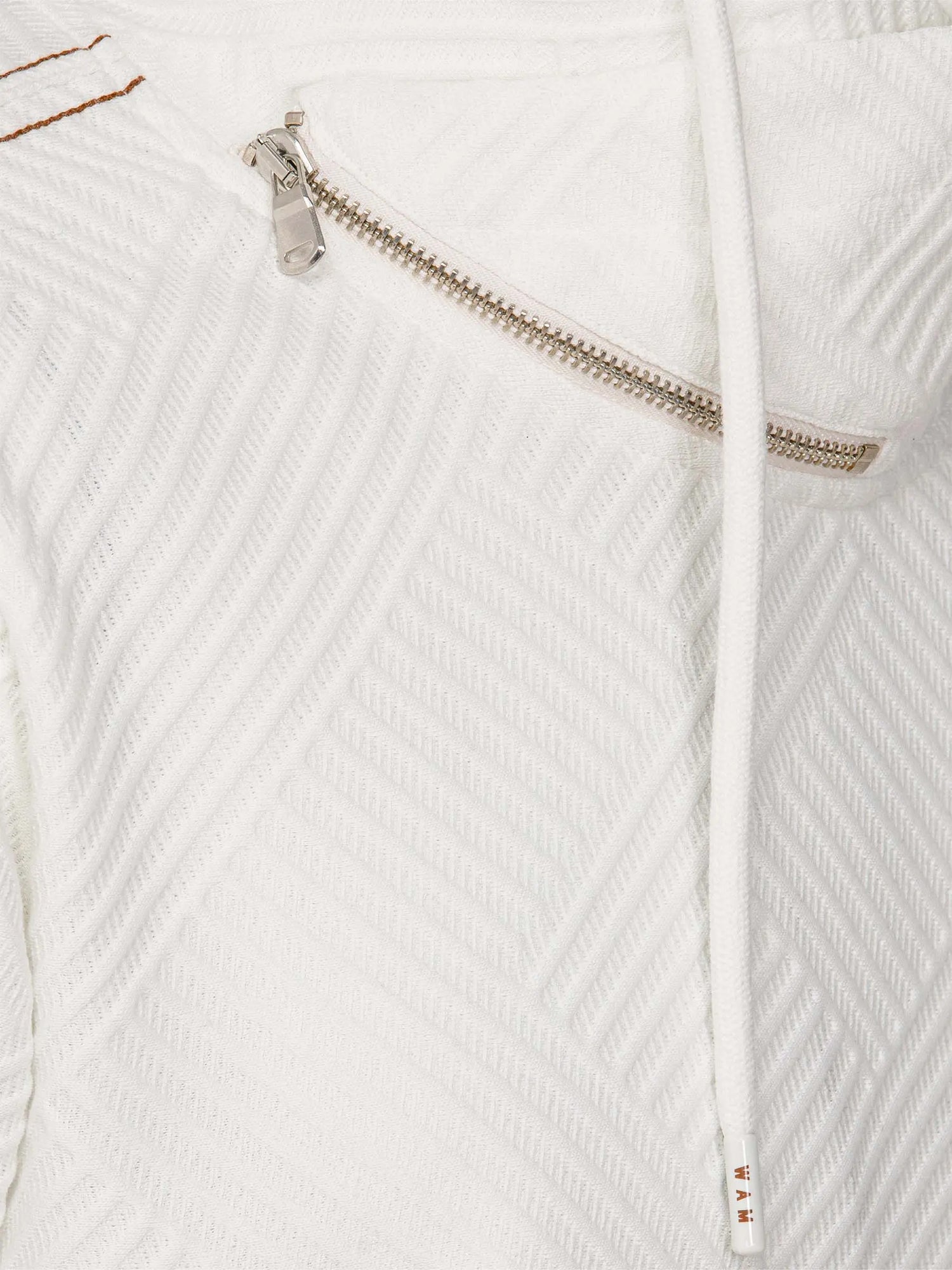 Close-up of white sweatshirt zipper and drawstring with textured geometric pattern – Wam Denim.