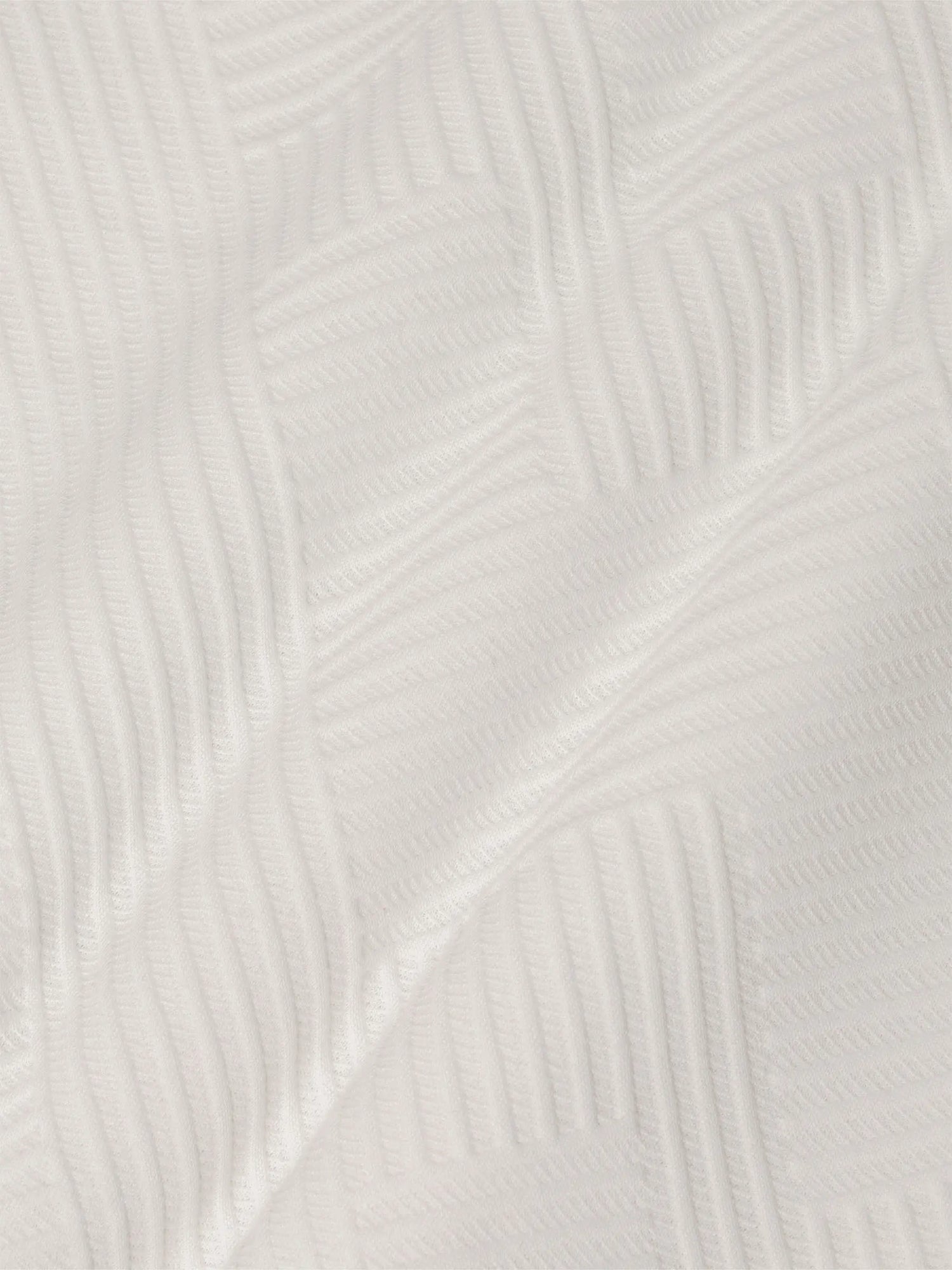 Close-up of white sweatshirt fabric featuring soft geometric textured pattern – Wam Denim.