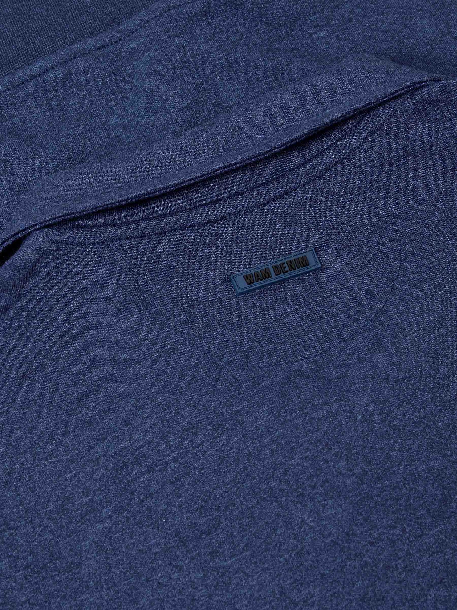 Back collar close-up with embossed Wam Denim logo on light indigo fabric – Wam Denim.