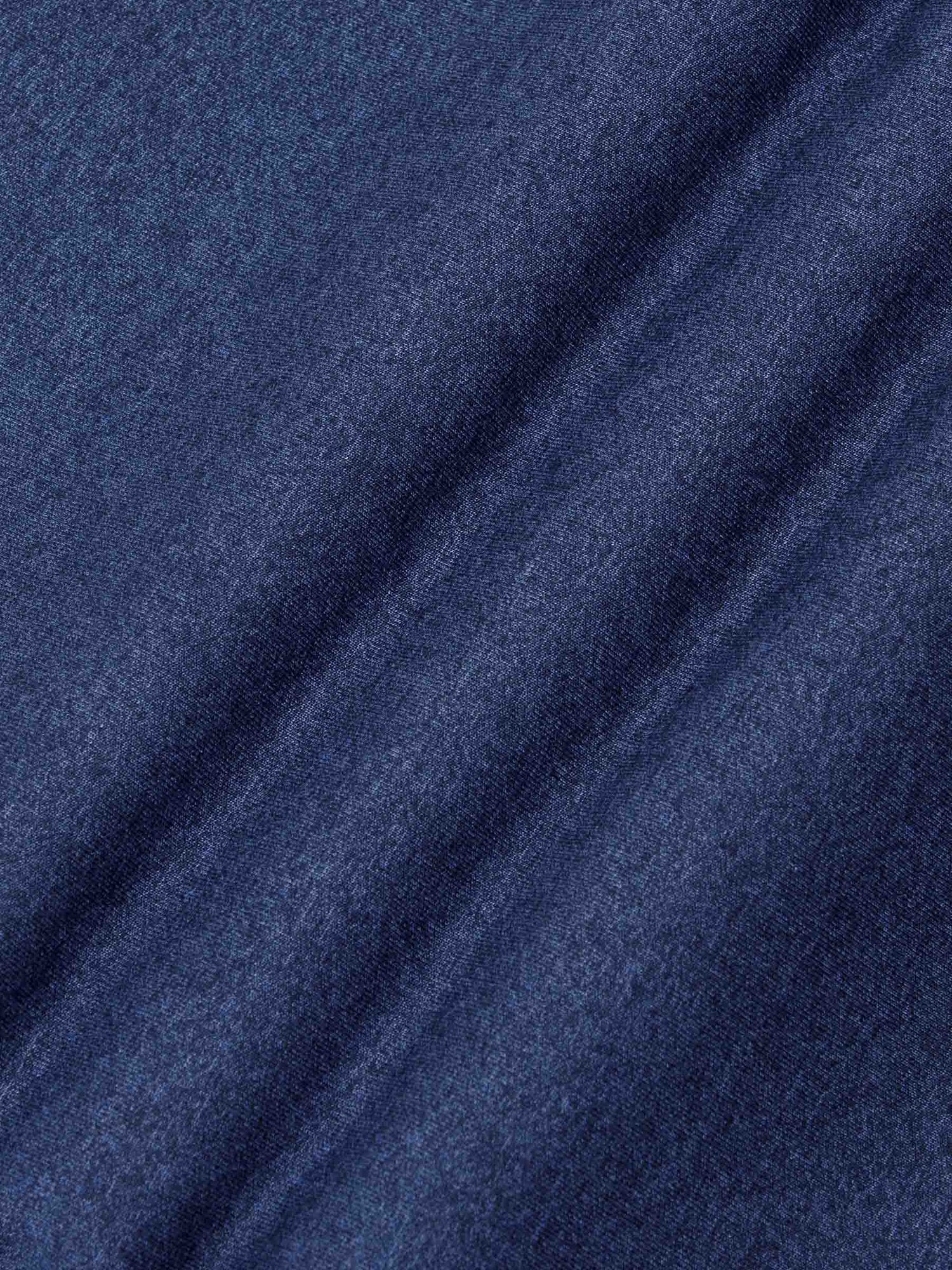 Close-up texture of light indigo knit fabric showing soft and smooth weave – Wam Denim.