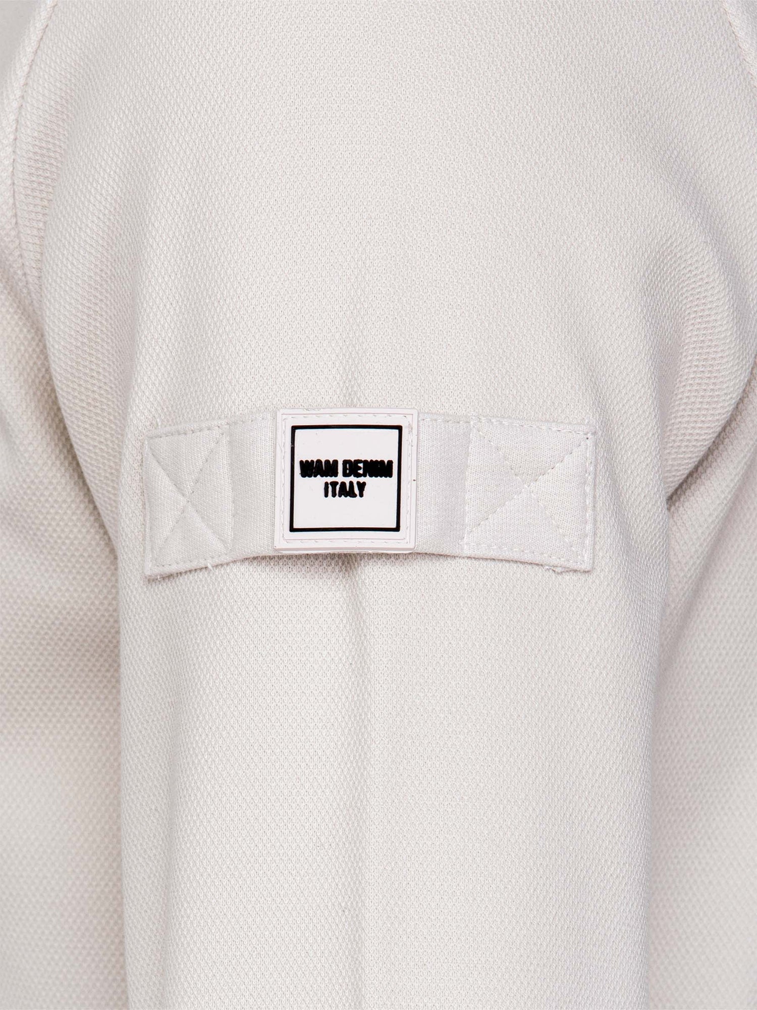 Close-up of light beige Milburn Sweater with tag. – Wam Denim.