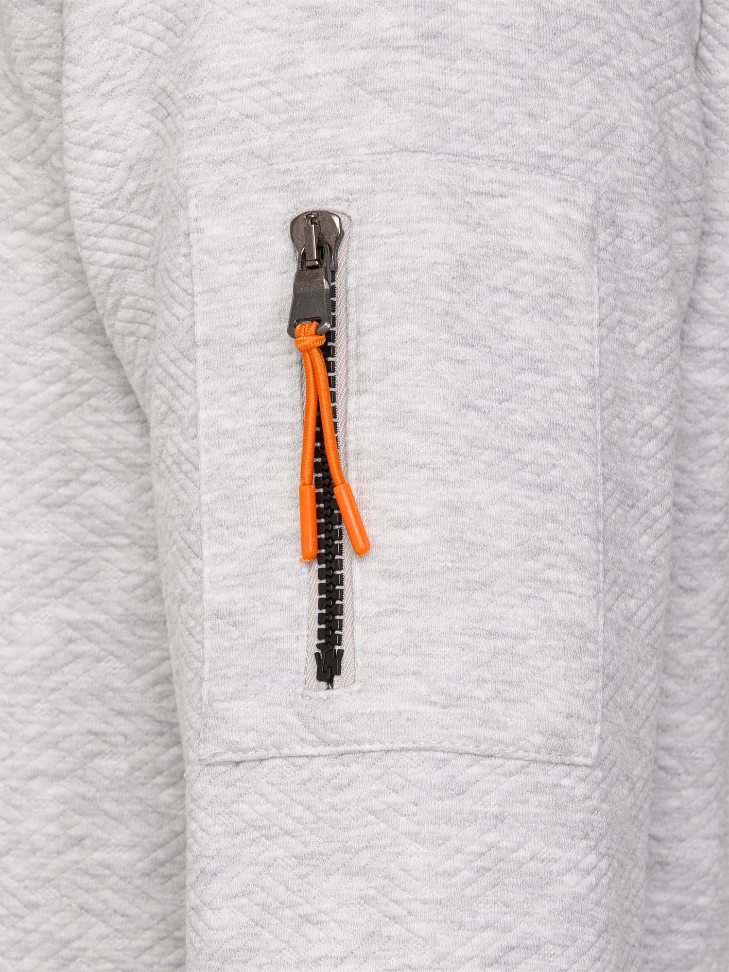 Close-up of grey textured sweatshirt sleeve with orange zipper pocket detail – Wam Denim.