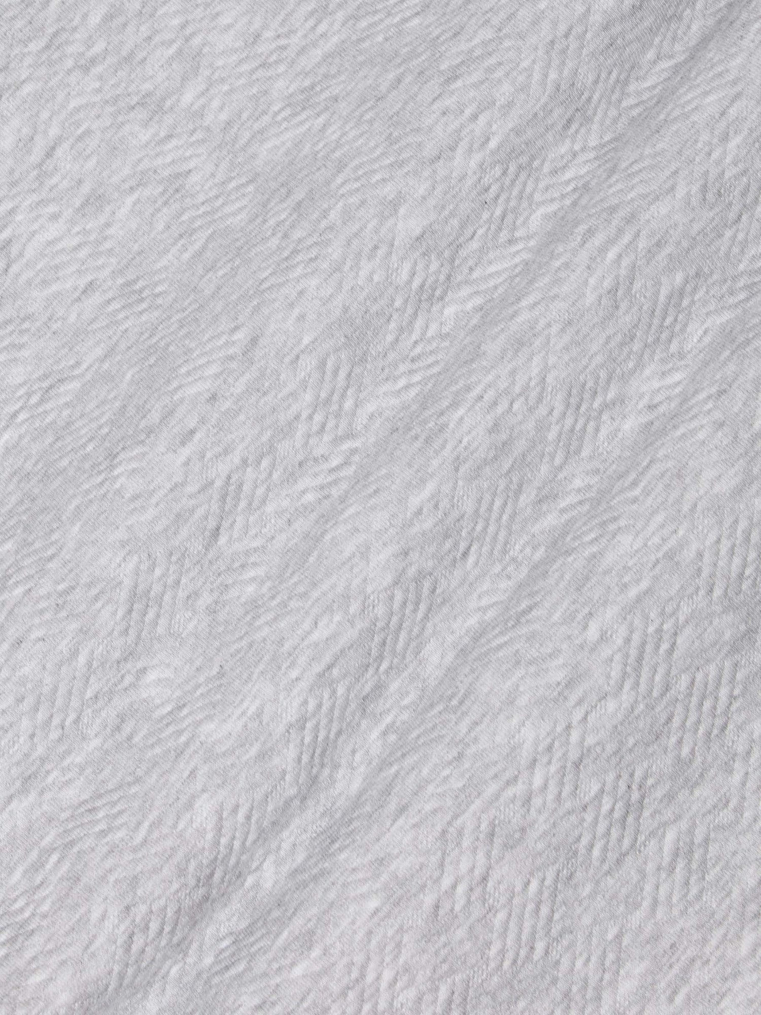 Close-up of light grey textured fabric showcasing soft herringbone knit pattern – Wam Denim.