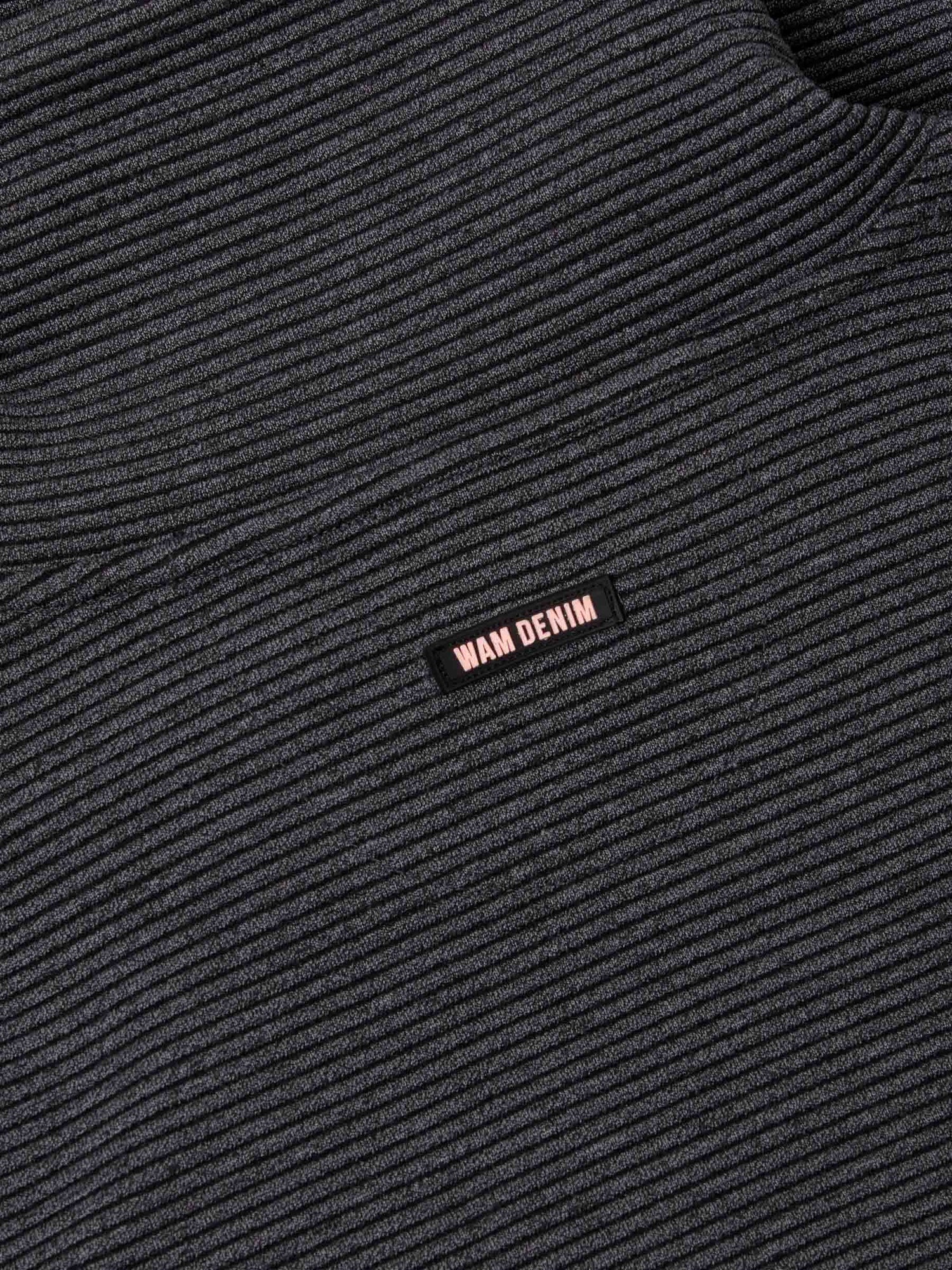 Close-up of ribbed Anthracite fabric featuring a small woven Wam Denim logo tag – Wam Denim.