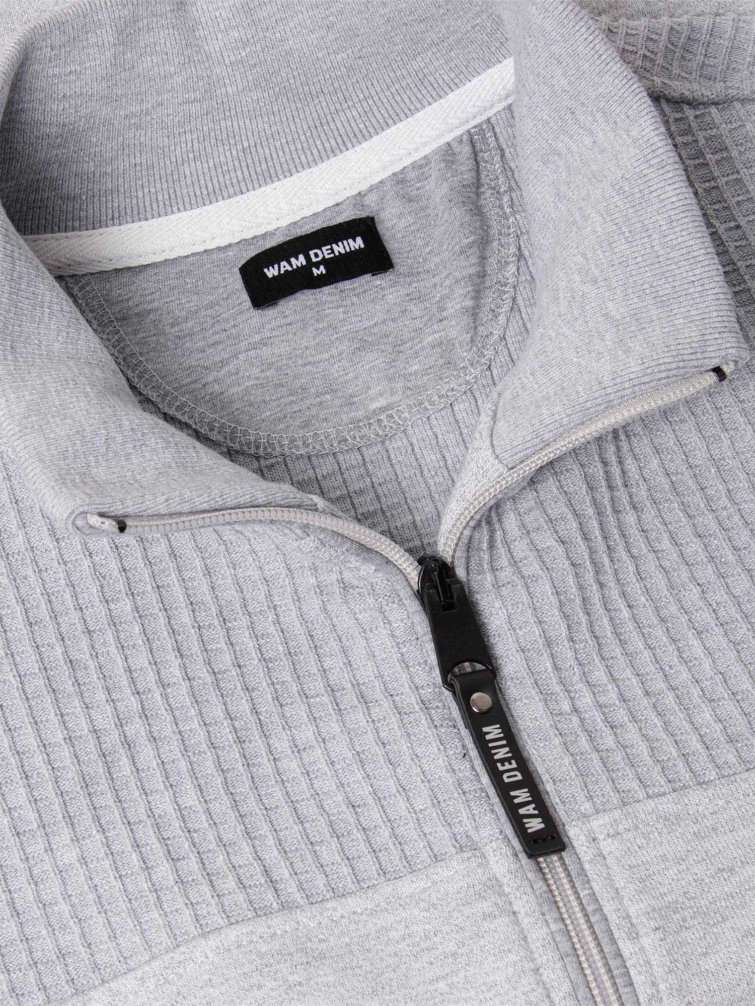 Close-up of The Fletcher Light Grey Vest zipper and ribbed collar detailing with Wam Denim tag – Wam Denim.