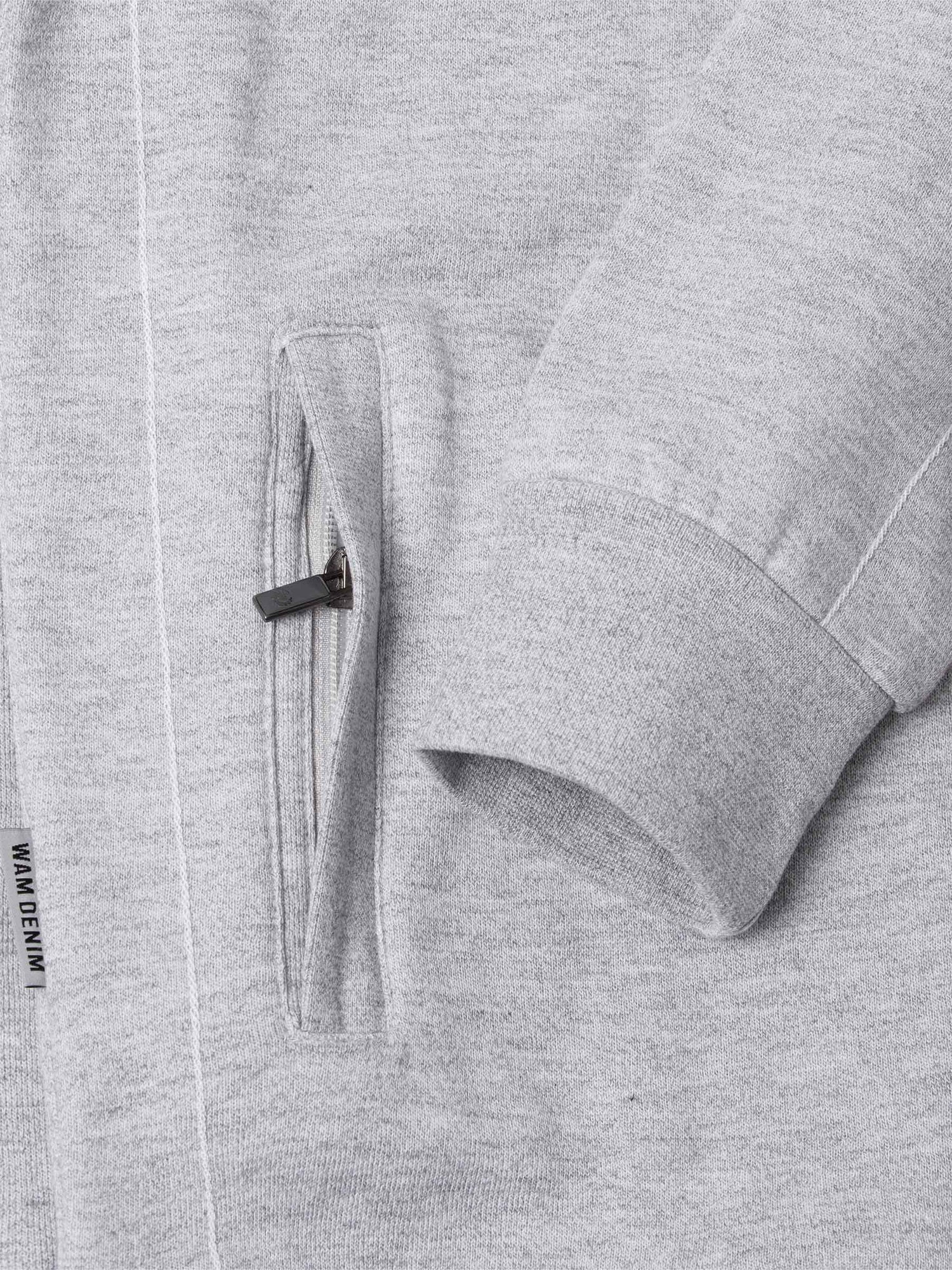Close-up of The Fletcher Light Grey Vest pocket and cuff showing zip detail and label – Wam Denim.