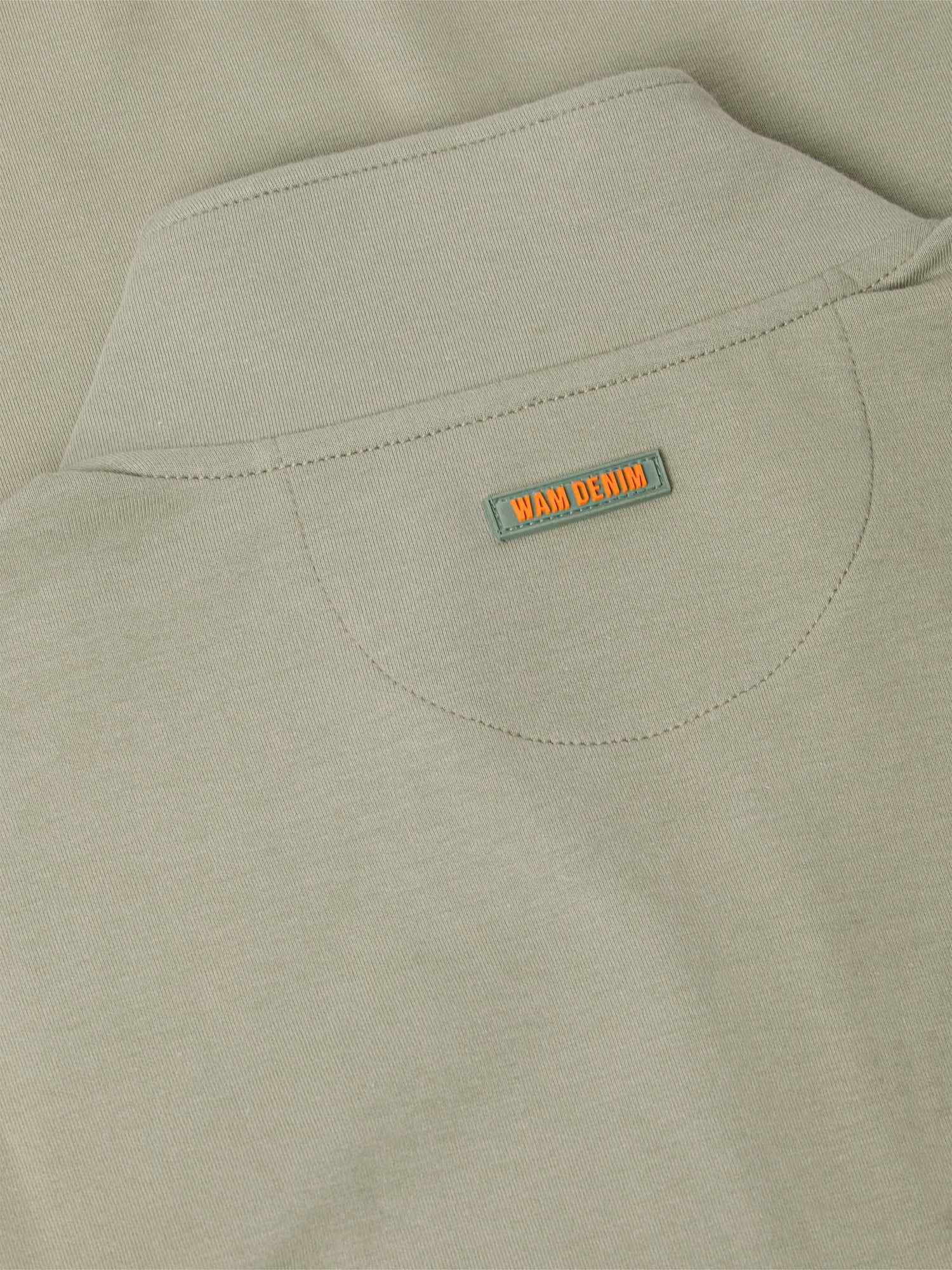 Close-up of a Light Green jacket with a 'WAM Denim' label on the chest pocket.