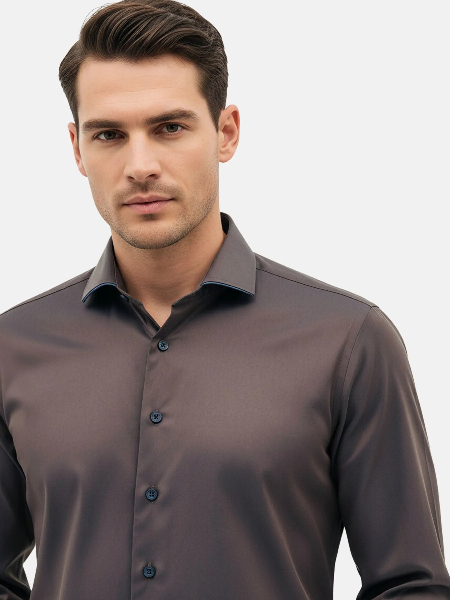 Close-up of men’s light brown dress shirt with modern collar and slim fit.