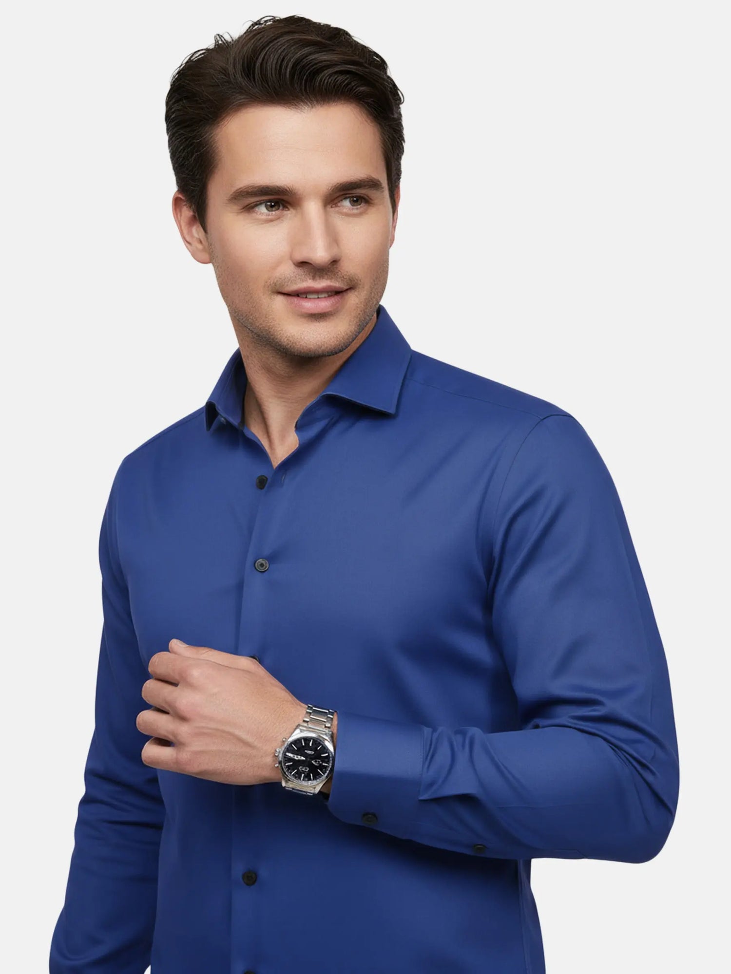 Close-up of a man wearing a royal blue dress shirt with black buttons.