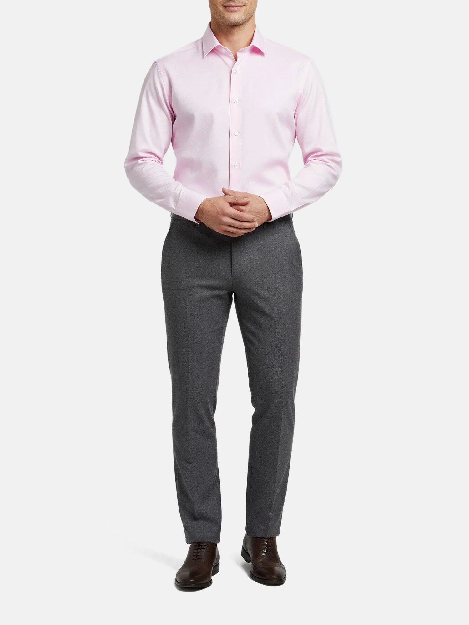 Model wearing pink dress shirt with grey trousers, smart formal outfit.