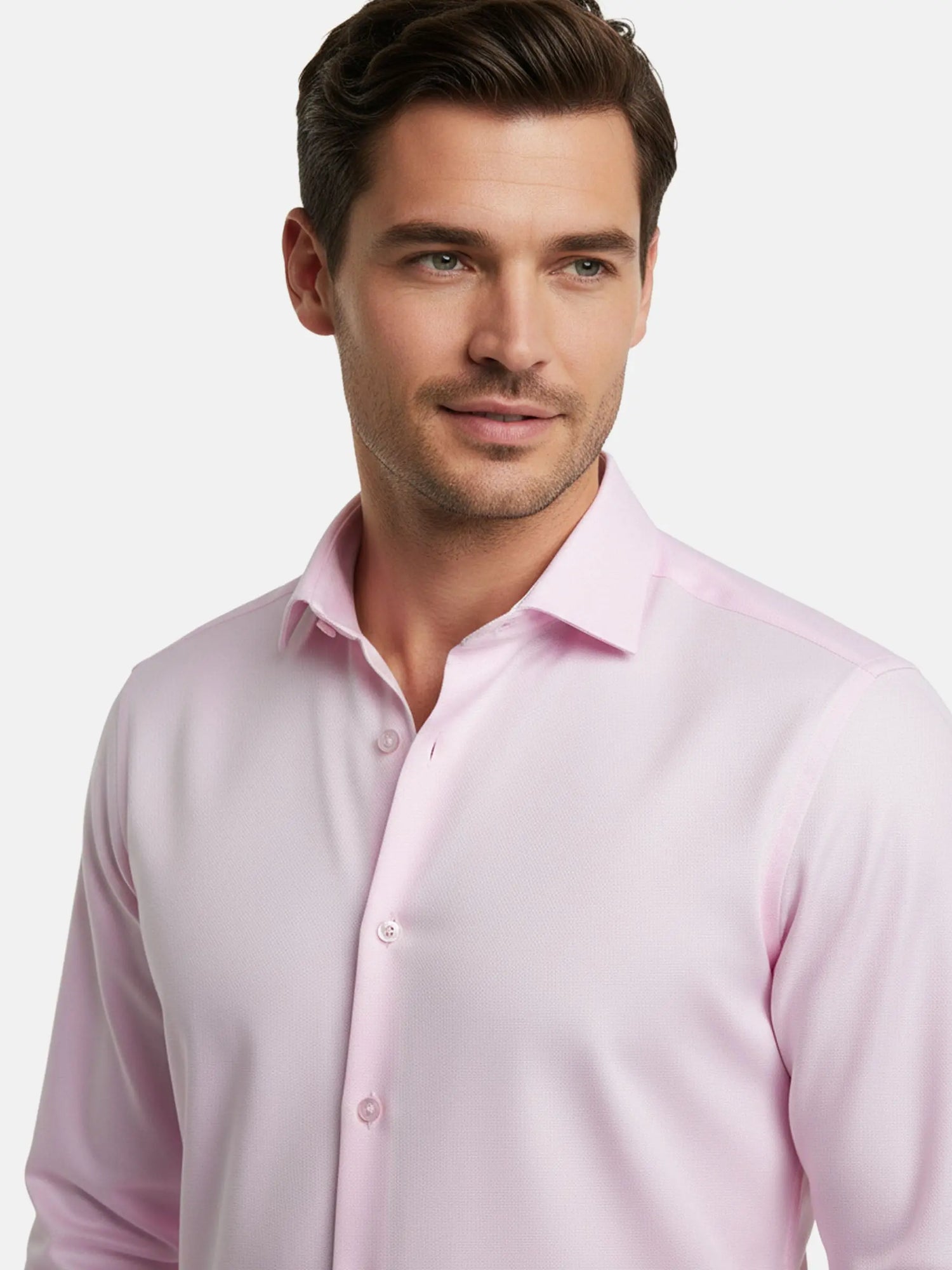 Model wearing pink dress shirt with classic collar, close-up view.