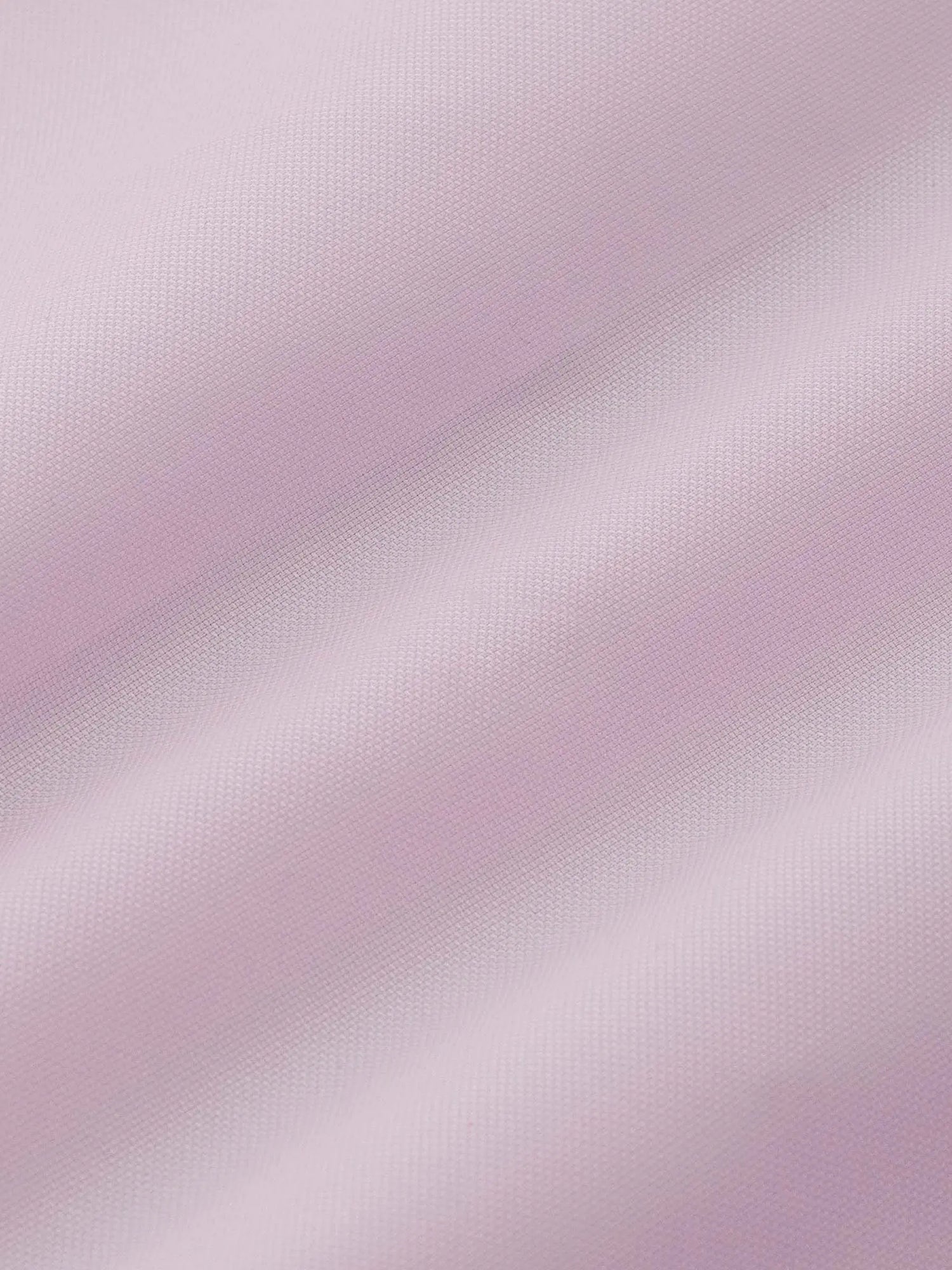 Close-up texture of pink dress shirt fabric, soft woven detail.