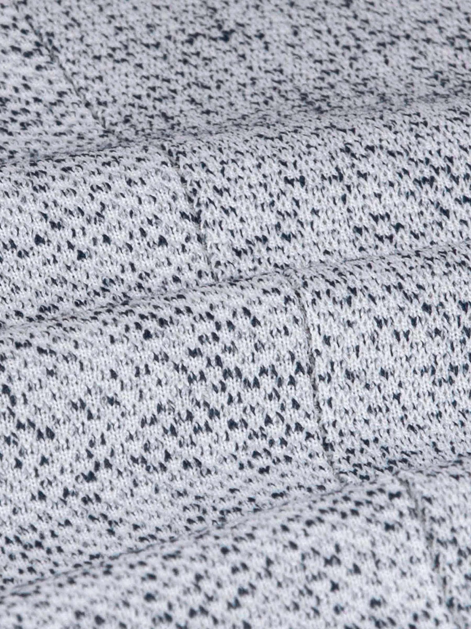 Close-up of the white-navy textured blazer fabric showing its detailed woven pattern.