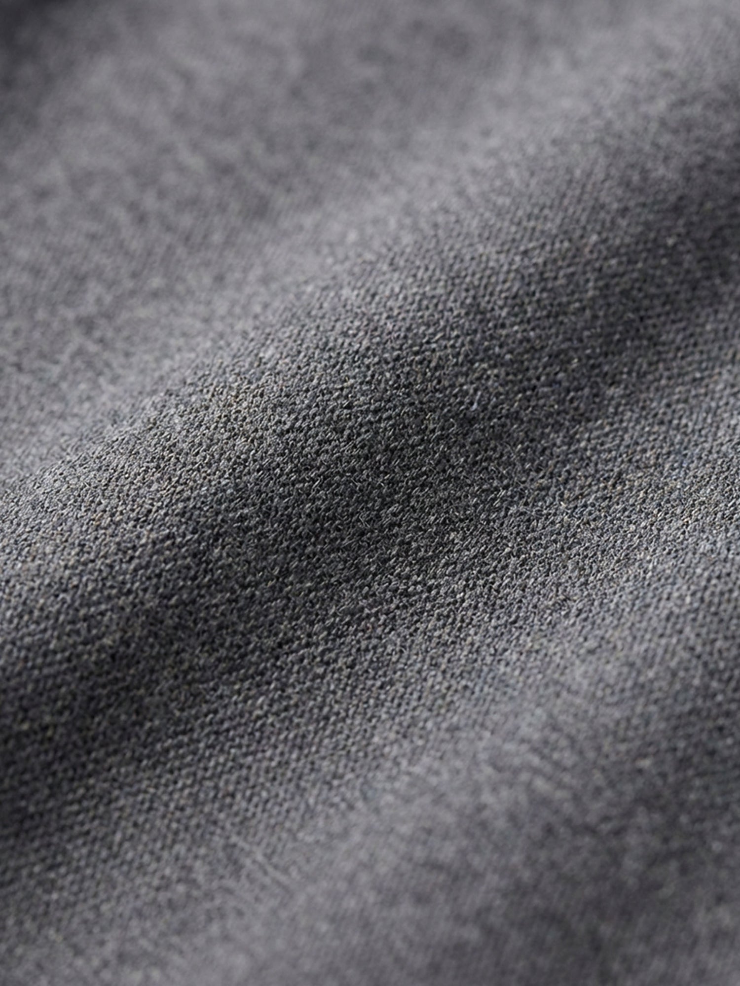Close-up of grey pantalon fabric texture highlighting soft, durable material detail.