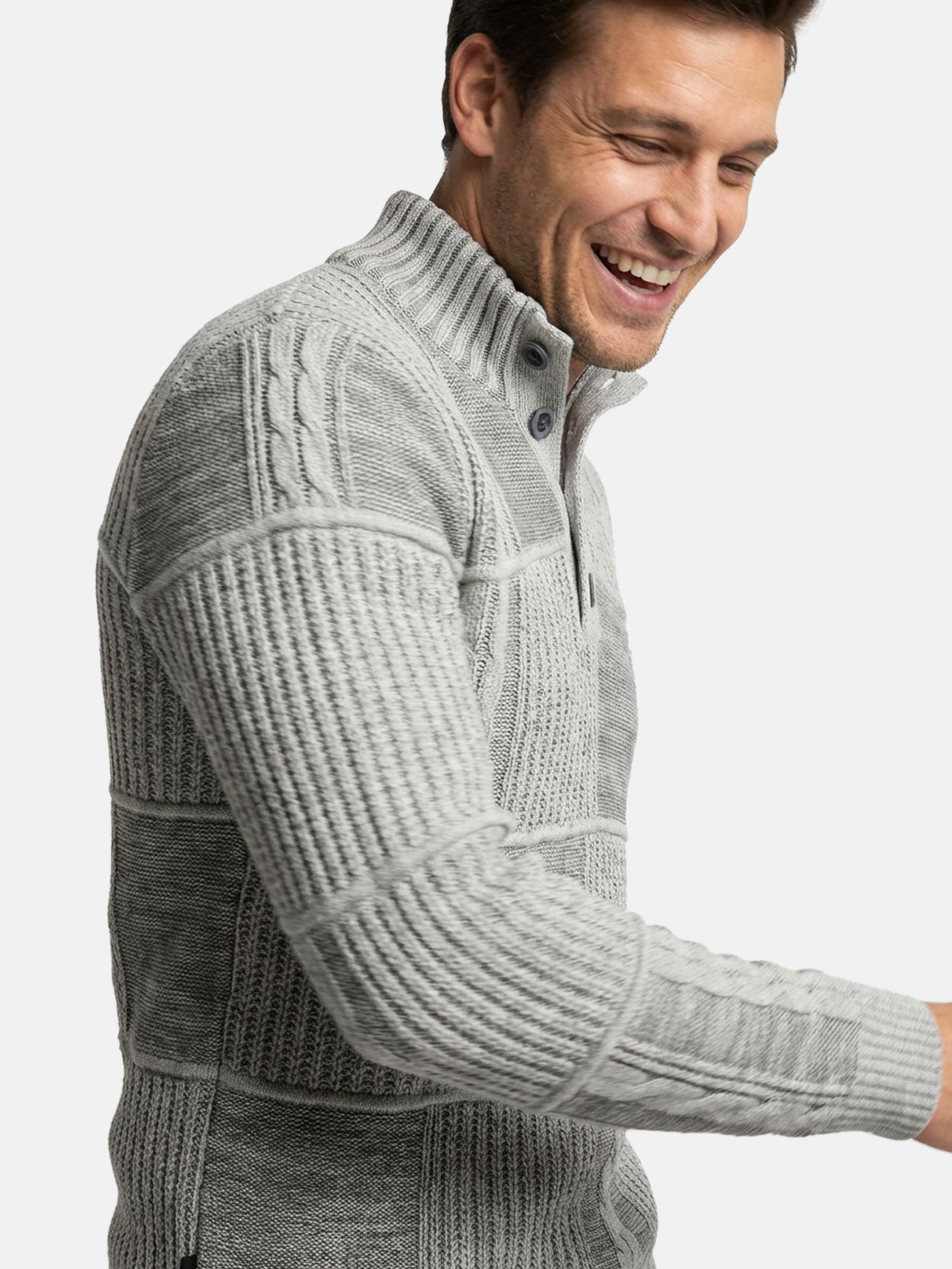 Close-up of light grey textured knit sweater with ribbed collar and panel detailing.