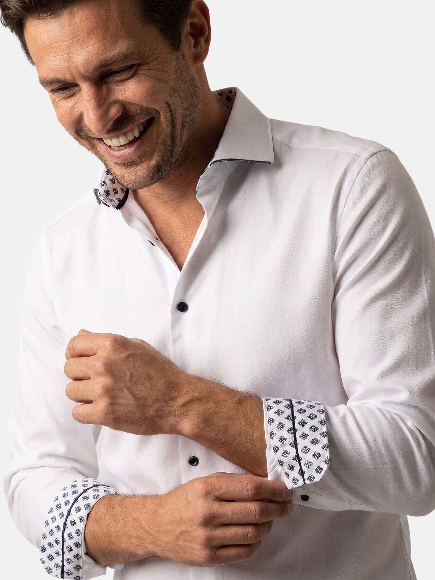 Close-up of white men’s dress shirt with patterned cuffs and collar detail