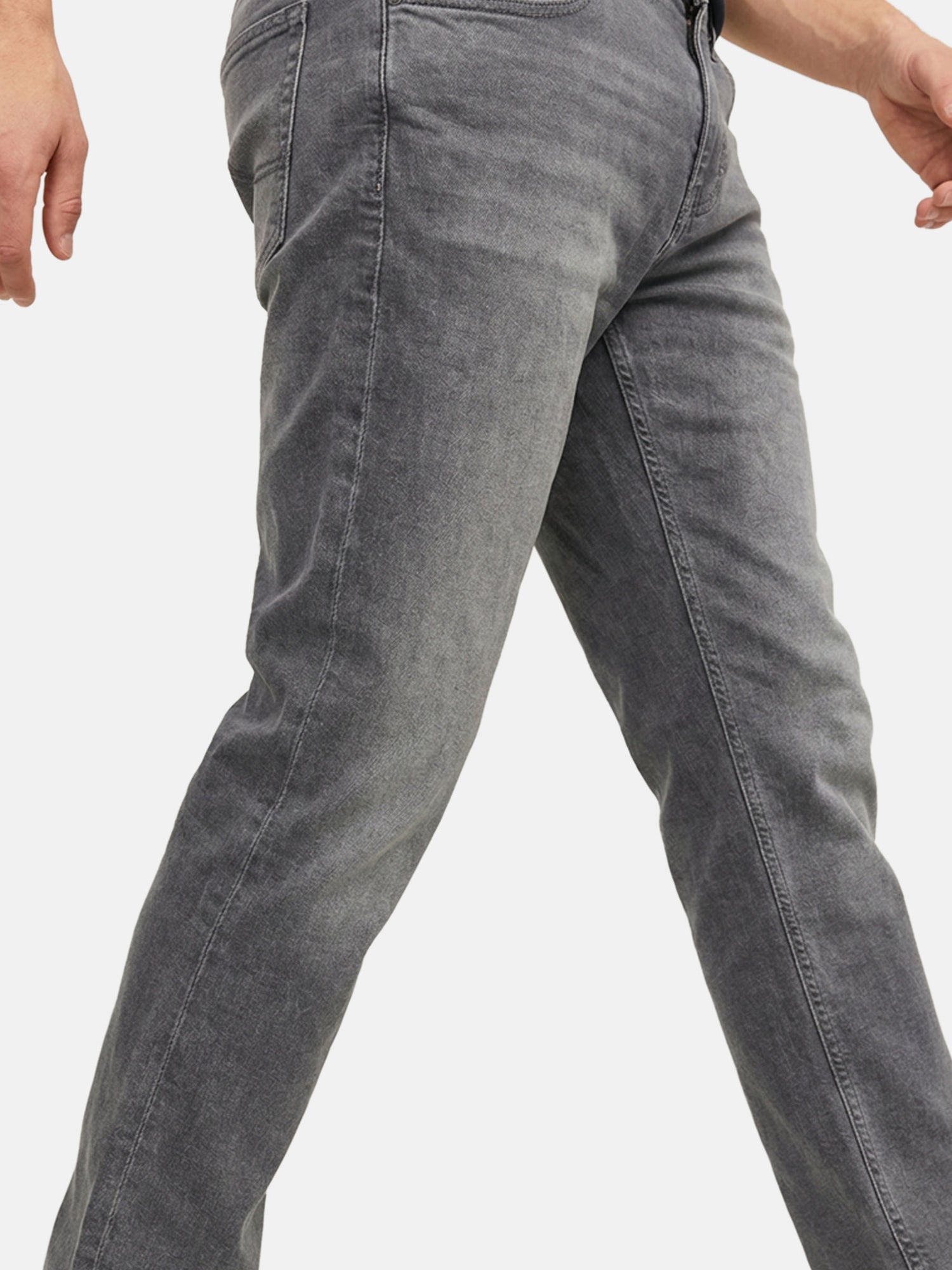 Close-up of grey denim jeans showing slim-fit leg and subtle faded texture.