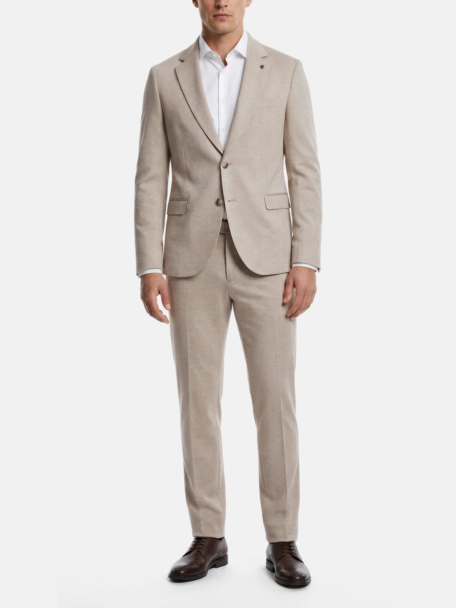 Model wearing beige blazer with matching suit trousers and tailored slim fit