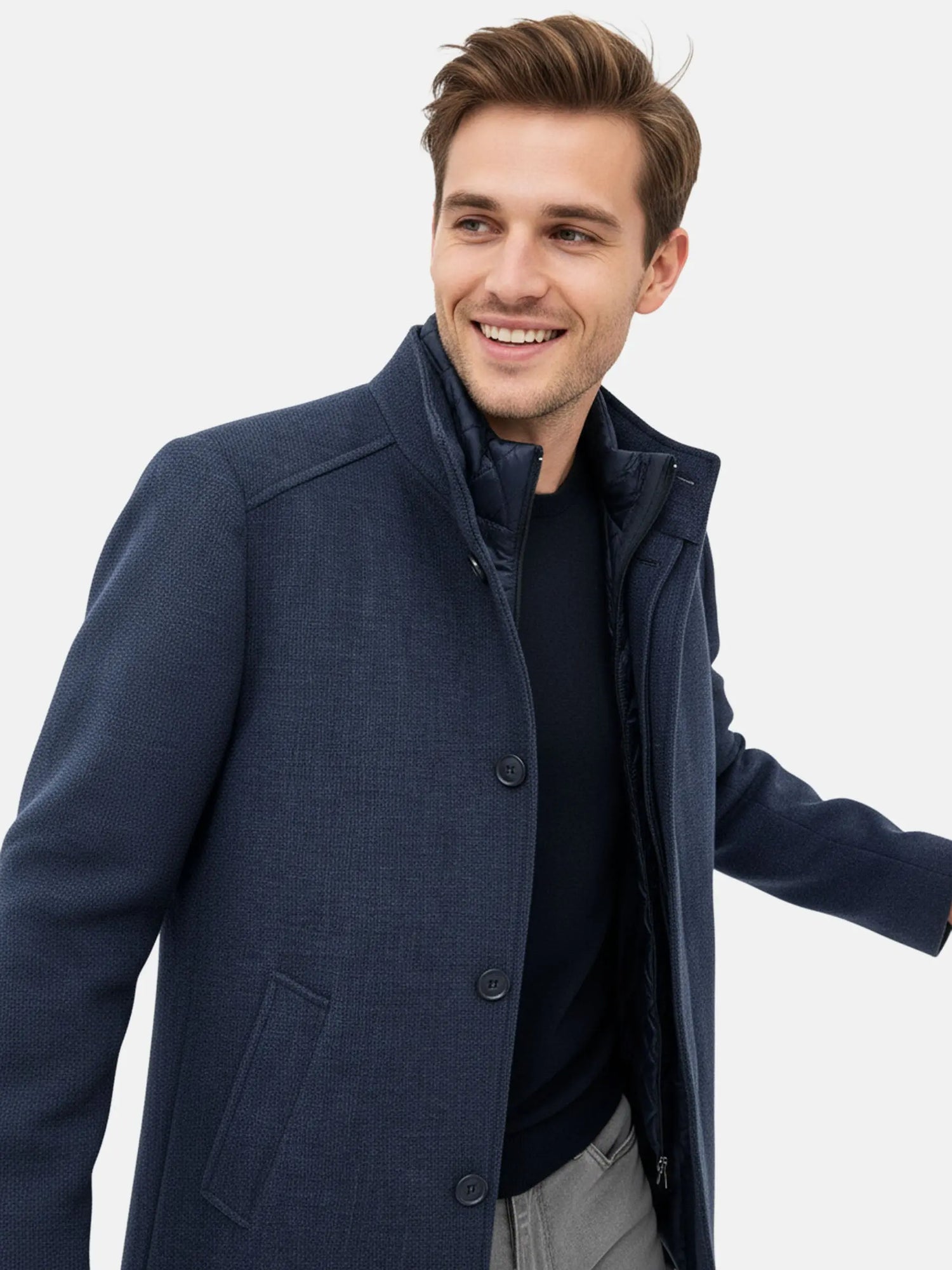 Close-up view of a man wearing a light navy trenchcoat with quilted inner collar.